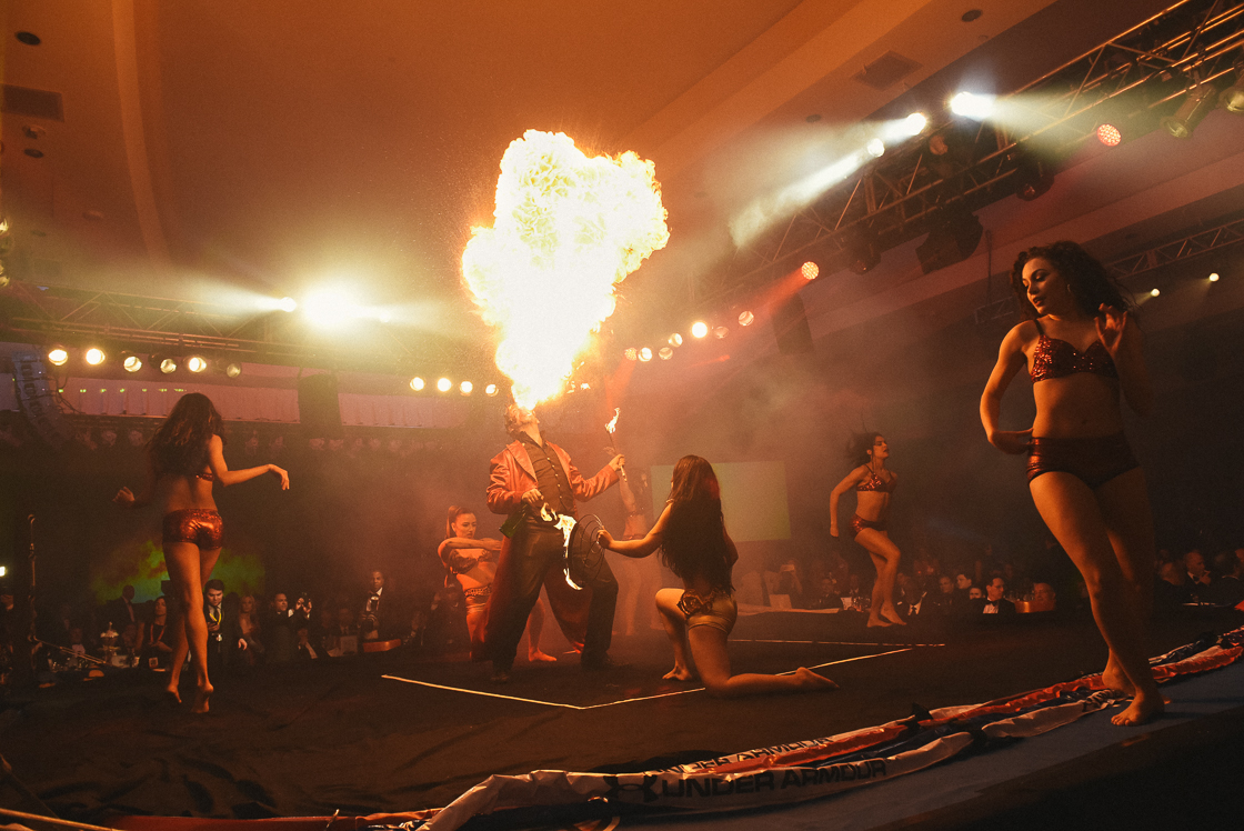 Pre-dinner live entertainment included a male fire eater with female dancers, and a pair of acrobats at the annual Fight Night benefit.