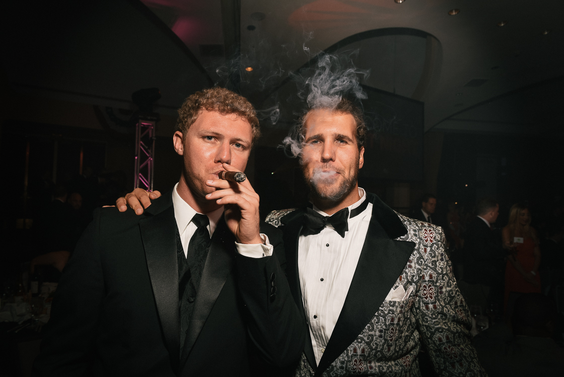 Jason Bisciotti and Harris Peace sample cigars before the arrival of their steak dinners.