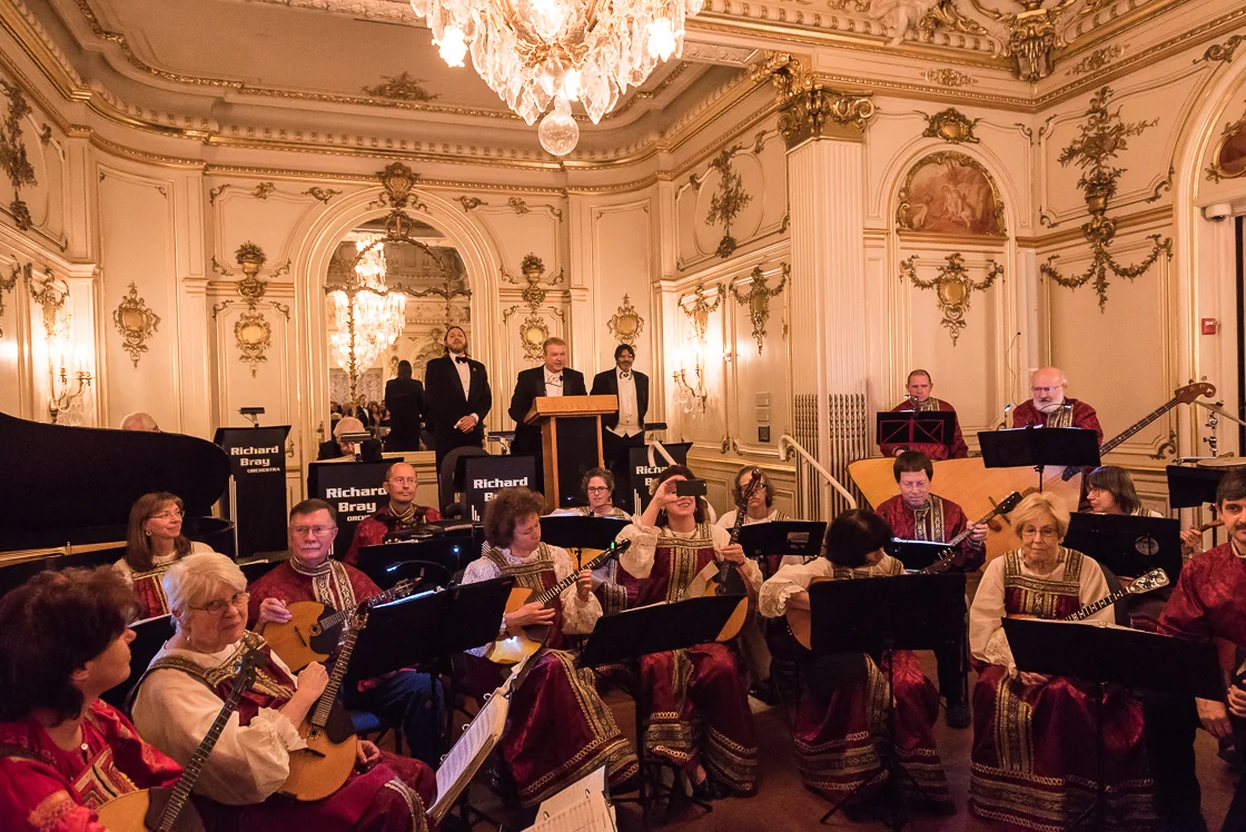Flanked by the Washington Balalaika Society, event chairman Paul du Quenoy welcomes guests to the annual Russian Ball with Prince Dimitri Obolensky (left) and Prince Nicholas Obolensky (right). 