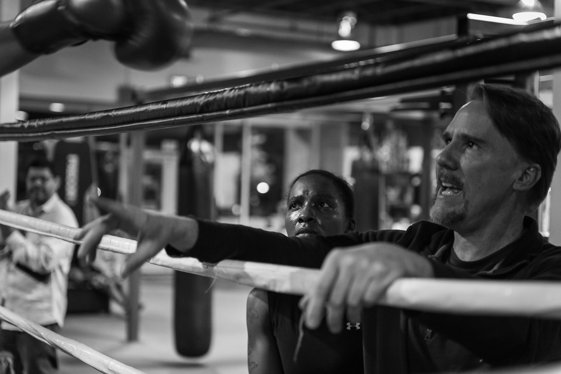 Nelson listens to her coach, Craig Fladager, give advice to another boxer. 