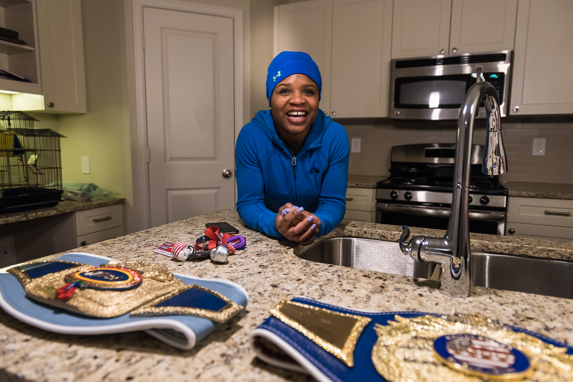 Tyrieshia Douglas, #1 ranked female bantamweight in the world, competed for the flyweight spot on the 2012 Olympic women's boxing team, the first year boxing was available to women. Here, she poses with her winning belts for #1 in the United States and the world.