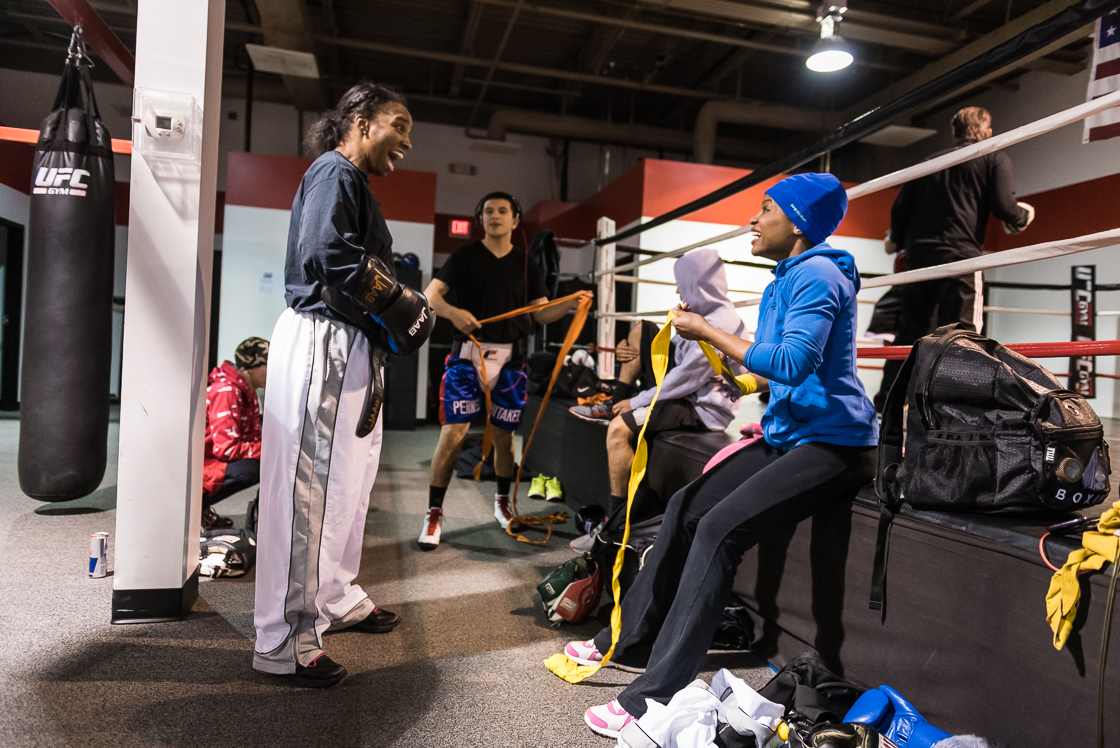 Nelson, left, and Douglas laugh together at their gym as they prepare to train. 