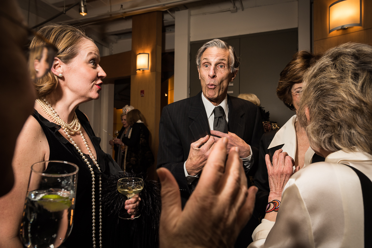 Guests at the gala wear attired in black and white creative black tie tailored to the 1920s theme. Bob Tracy, center, reacts animatedly to a story told by Janet Wittes (far left) as Christine Hollins (second from left) looks on and Marty Gross and Toni Ritzenberg chat nearby. 