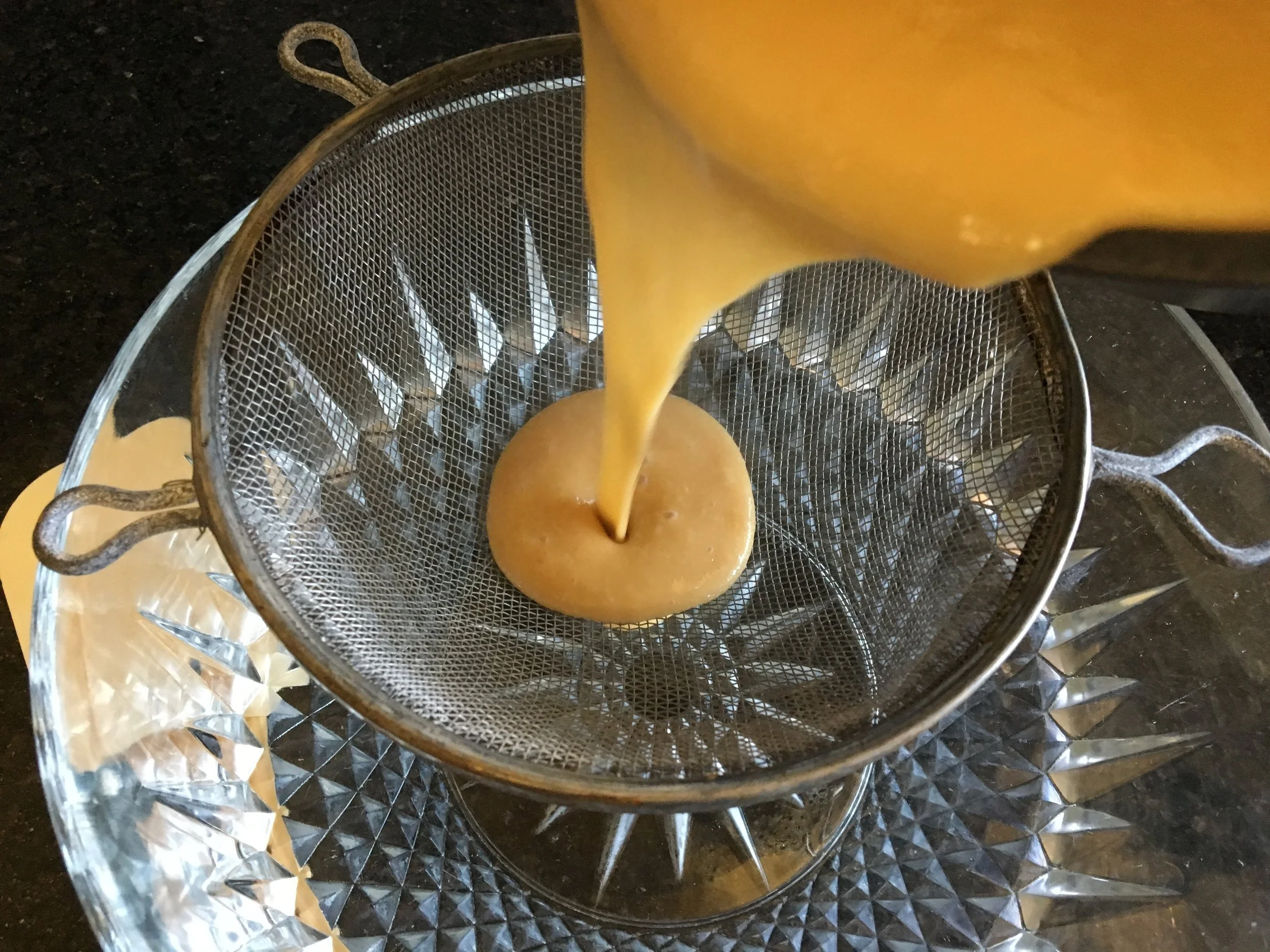 Straining the clumps to insure a nice smooth pudding.