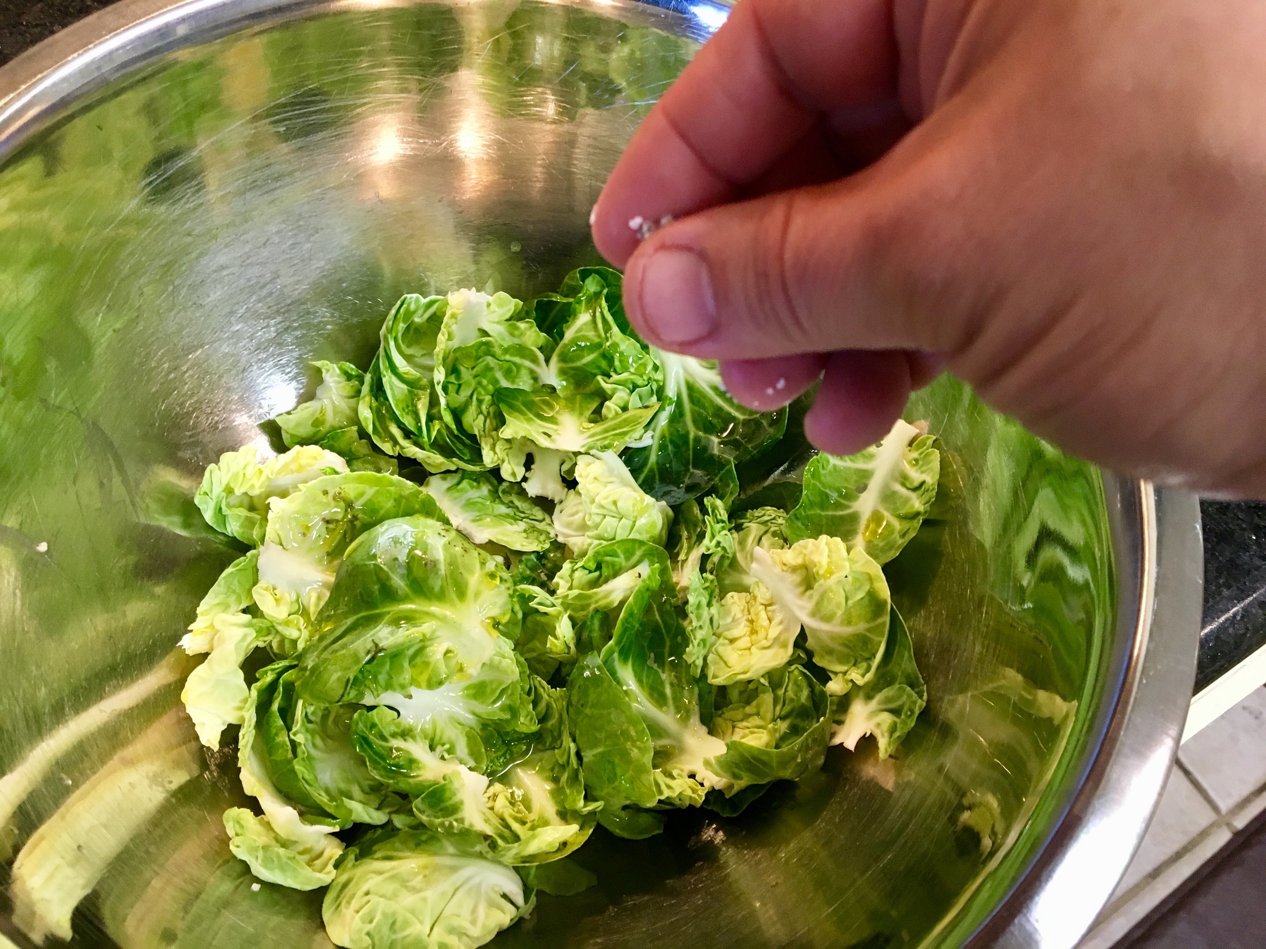 Prepping the Brussels sprouts leaves before oven frying 