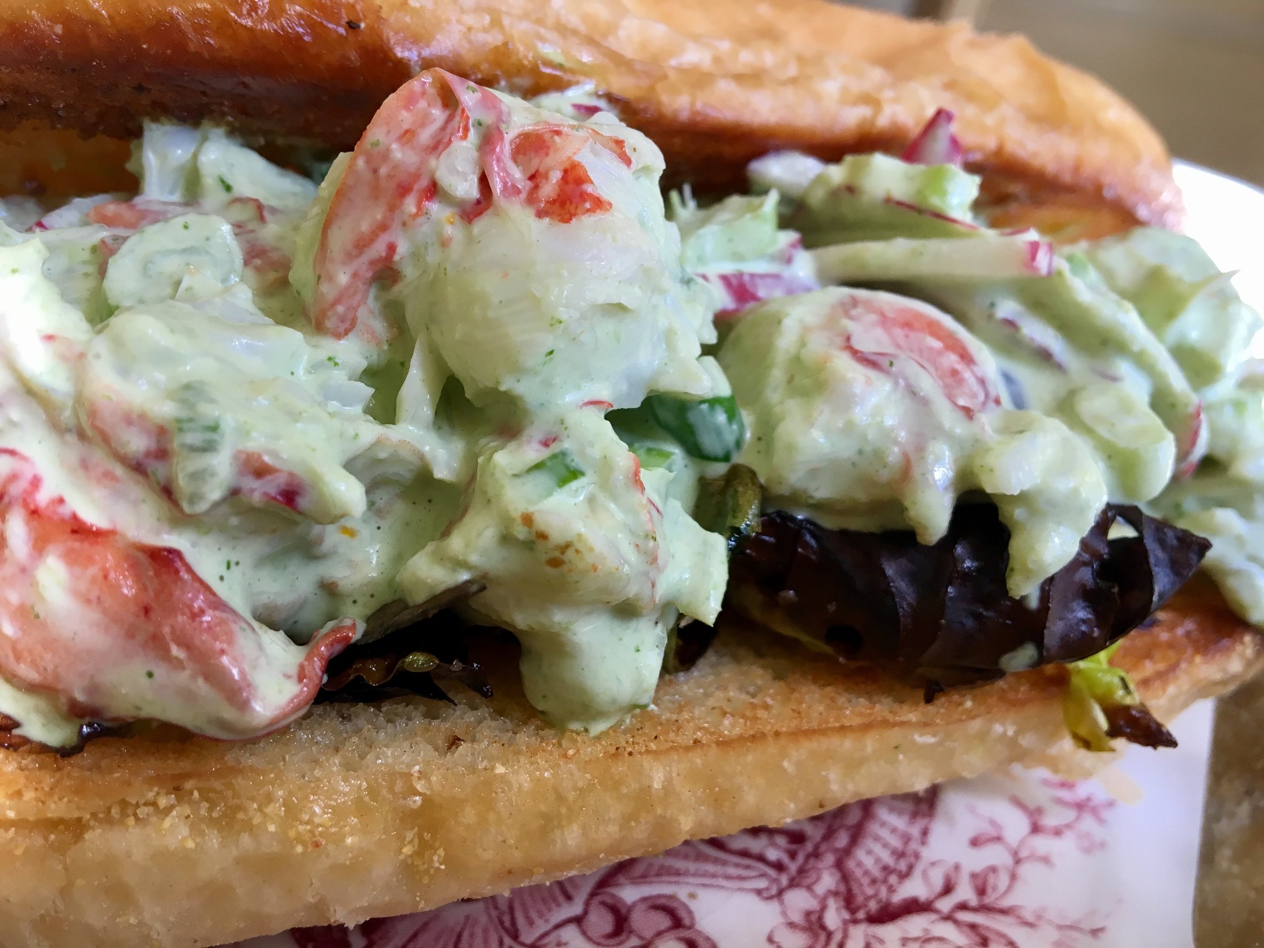 Butter fried roll, layer of crispy brussels sprouts, and a mound of Lobster salad. 