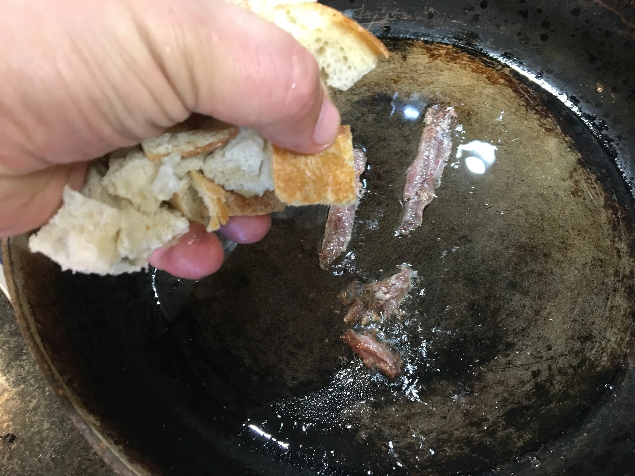 Pan frying the croutons with anchovy