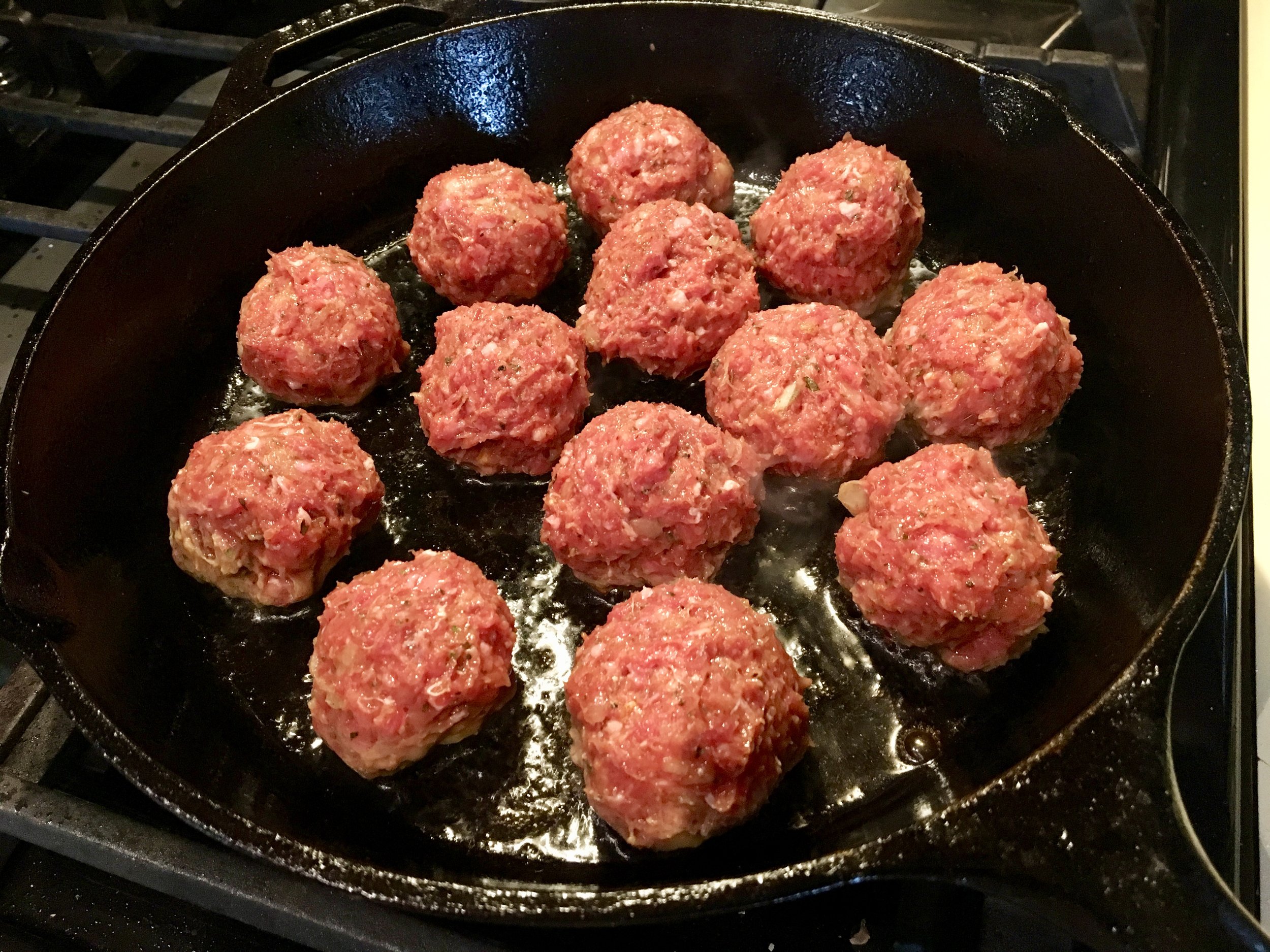 Minted and spiced Lamb Meatballs browning.