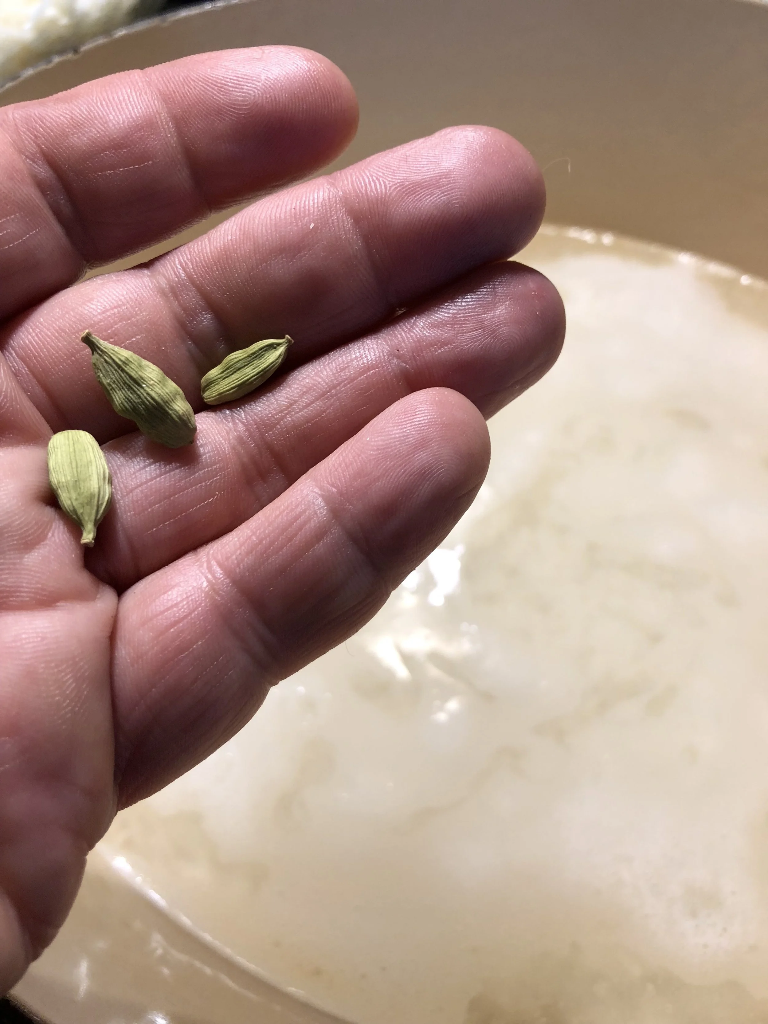 Cardamom pods. The green things... not my chubby fingers.