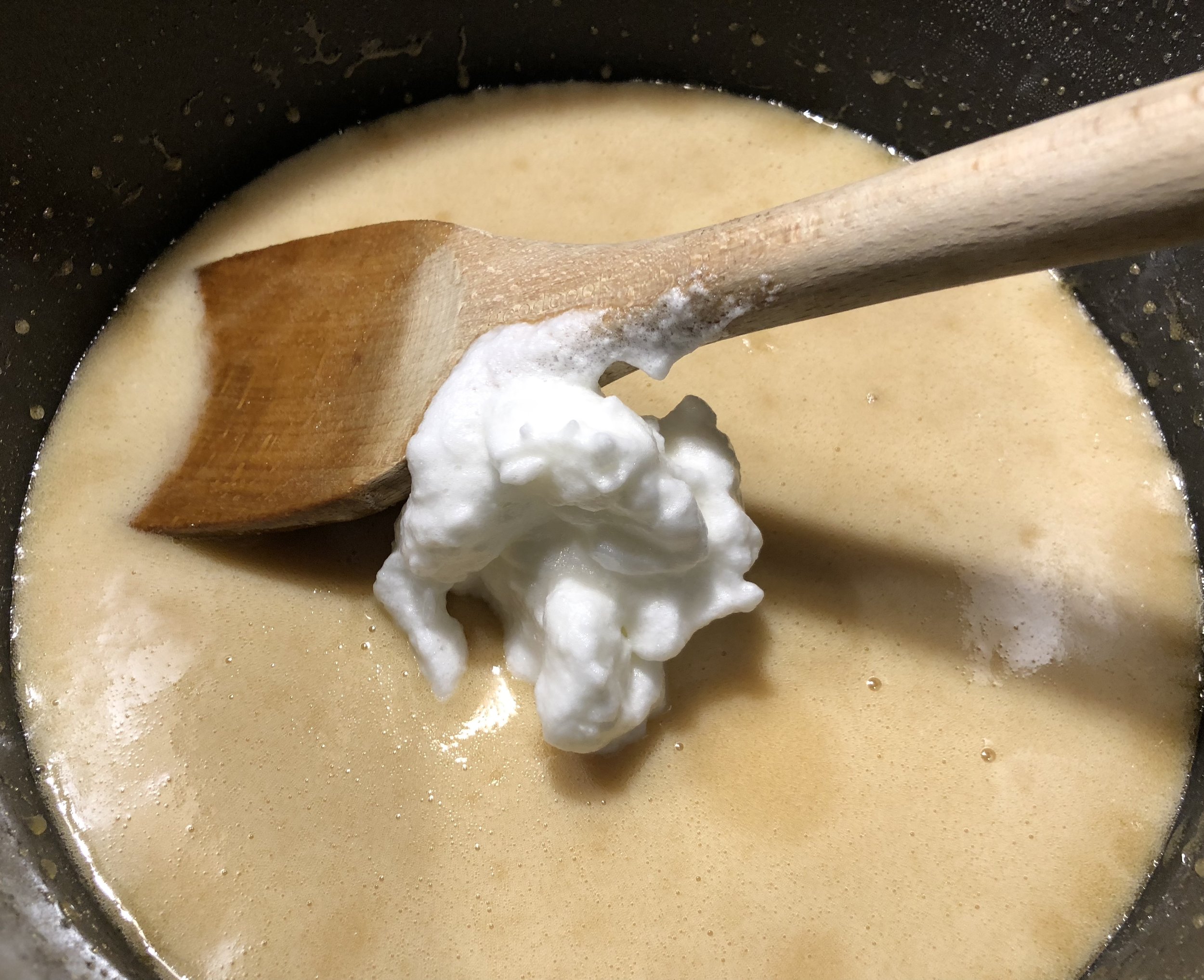 Adding one spoonful of whipped egg whites and mixing in a little at a time.