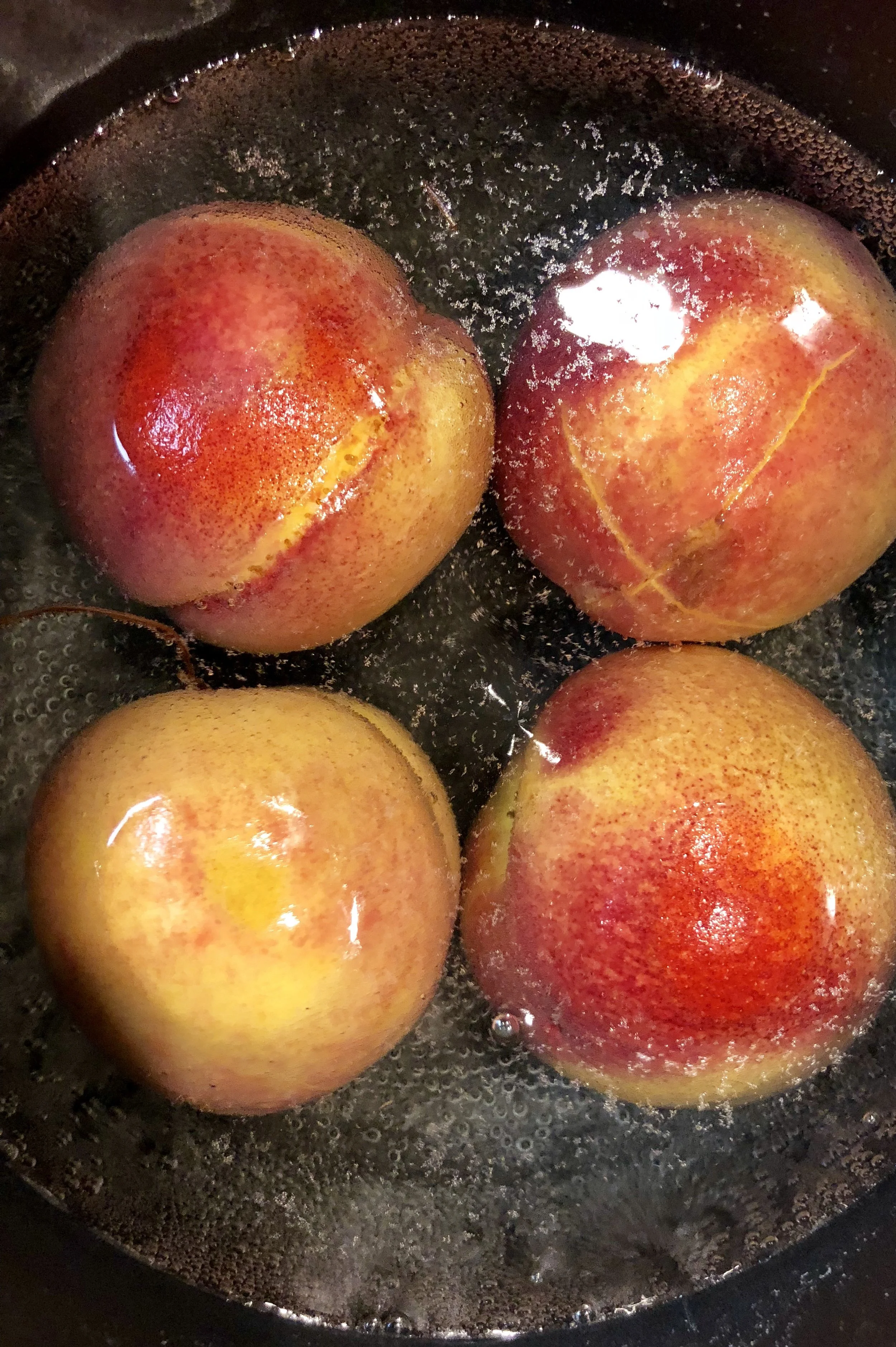 To remove the skin from peaches, "X" the top with a paring knife, place in a pot of water and bring to simmer. Remove from the heat and let stand for 10 minutes. Shock in ice water and peel the skin from the peaches. 
