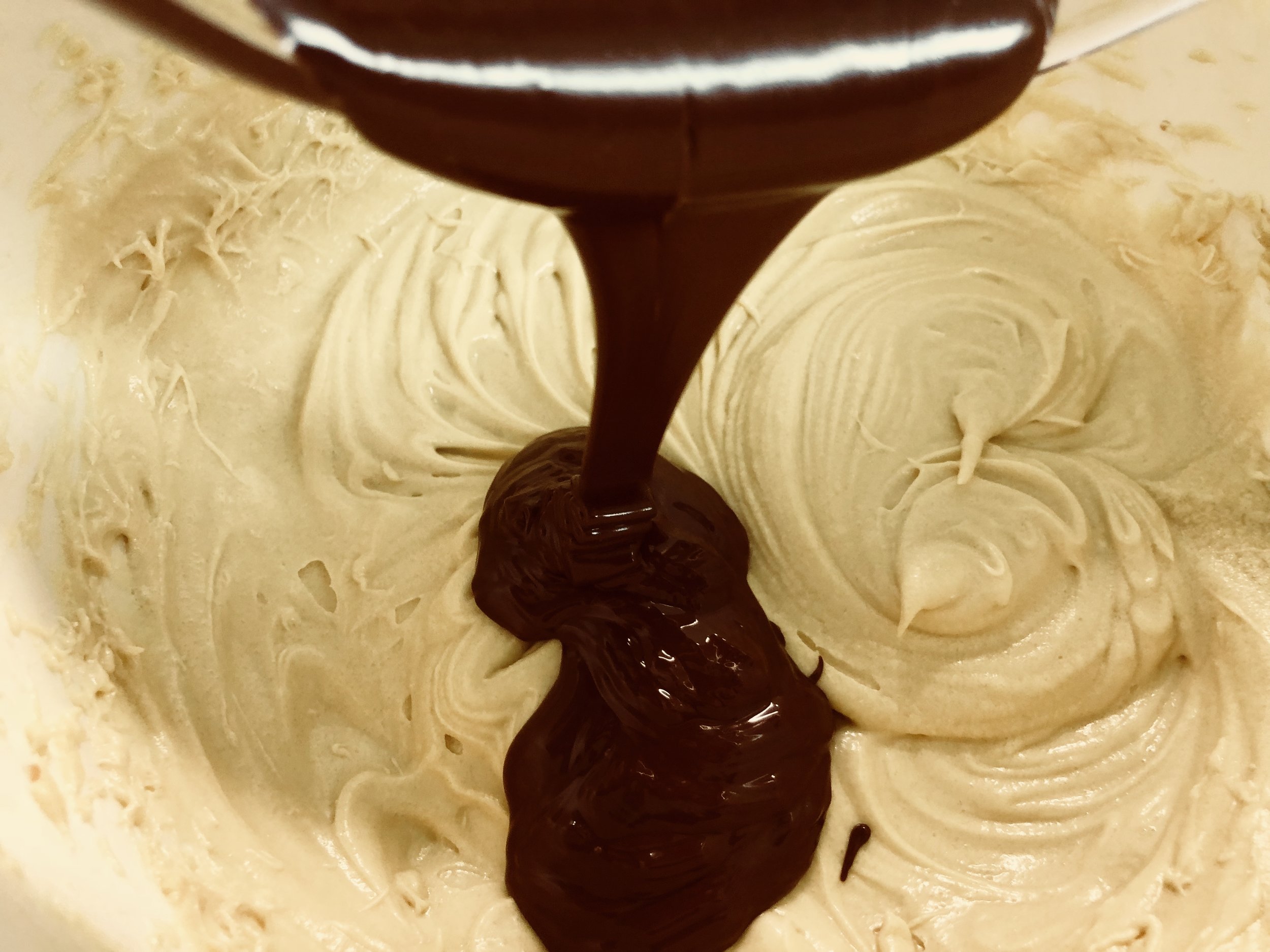 Adding rich bittersweet chocolate to the cake batter.