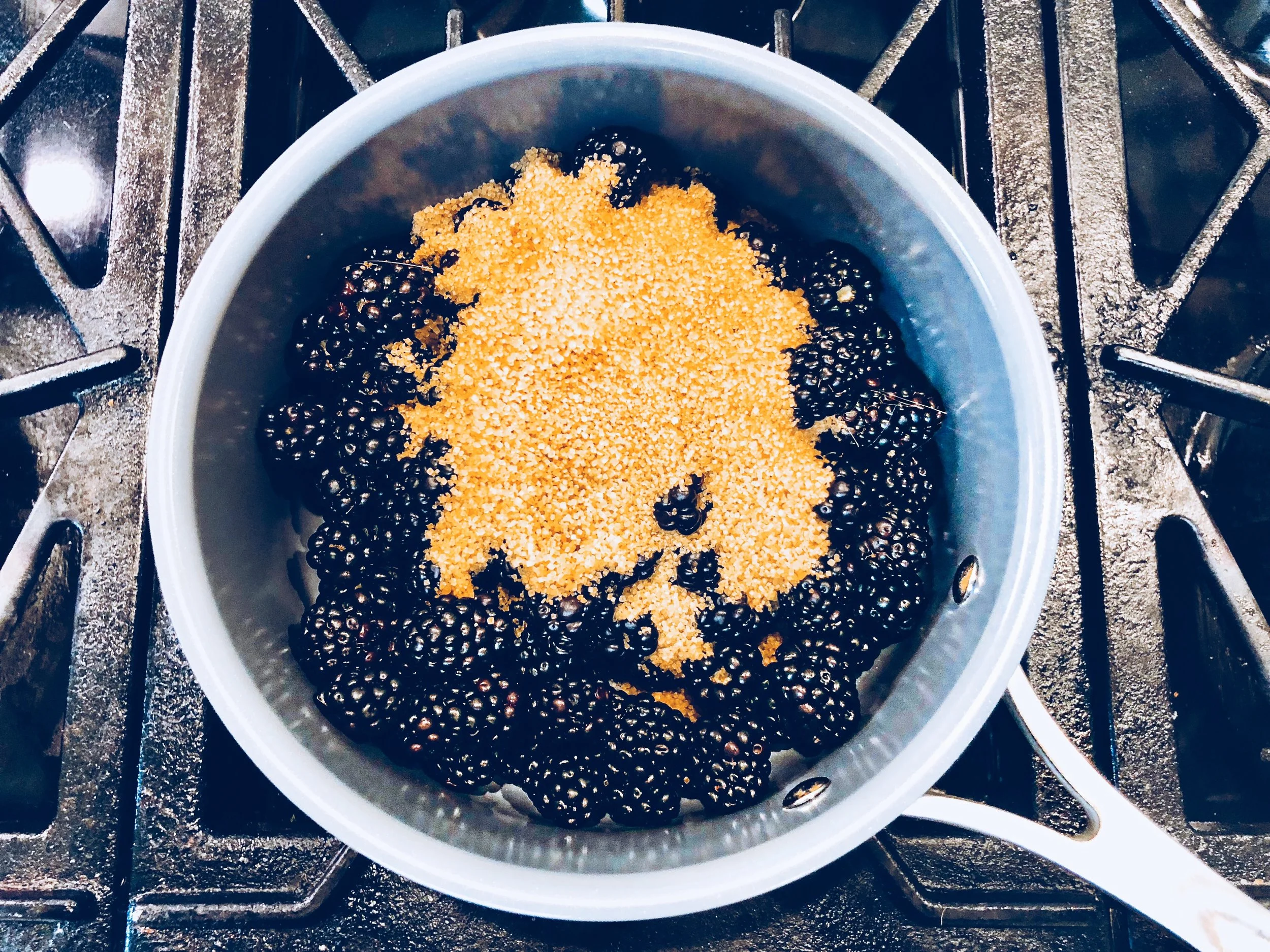 Cooking down the fresh blackberries with turbinado sugar. 