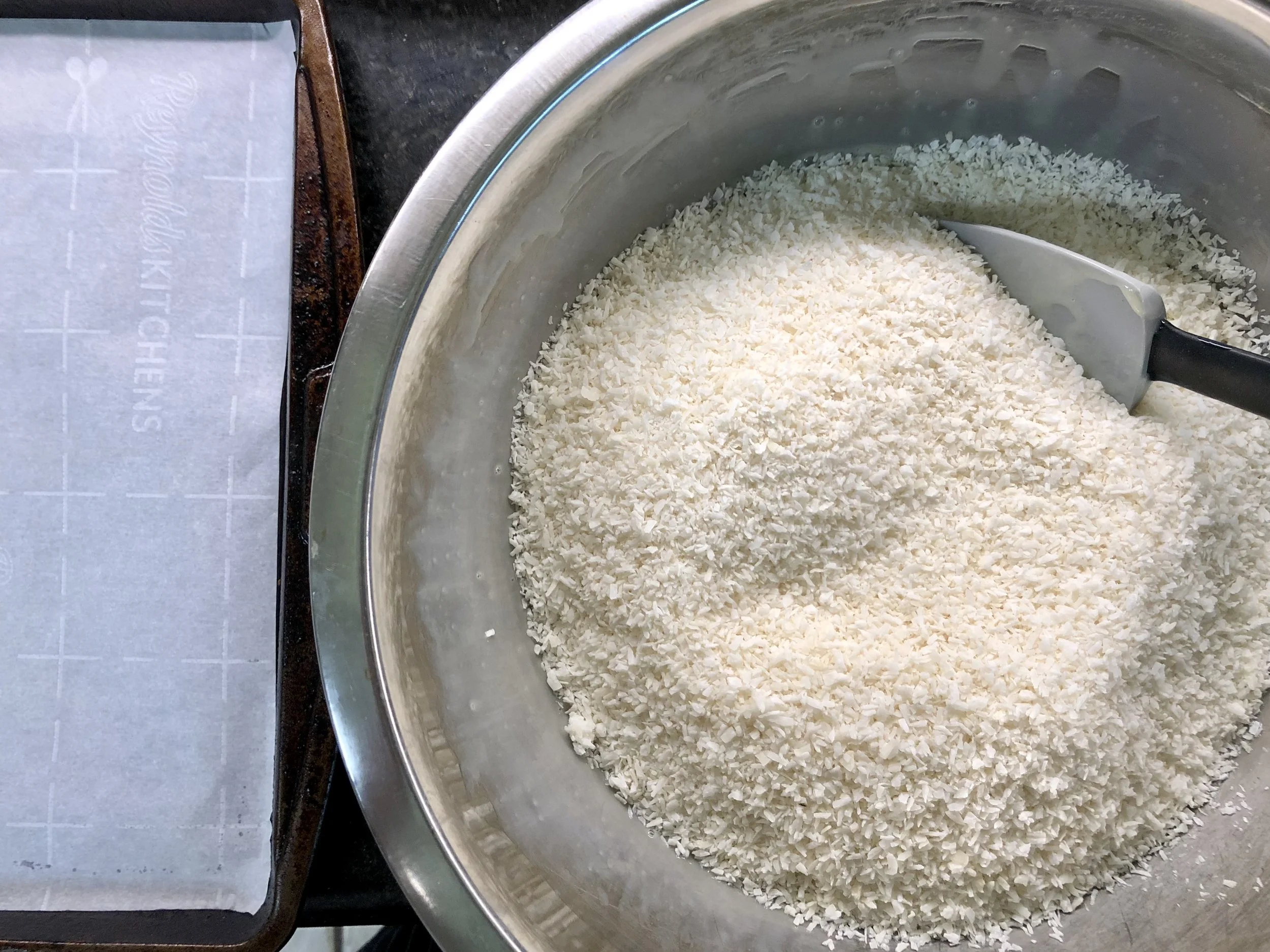 Unsweetened coconut added, ready to mix and scoop.