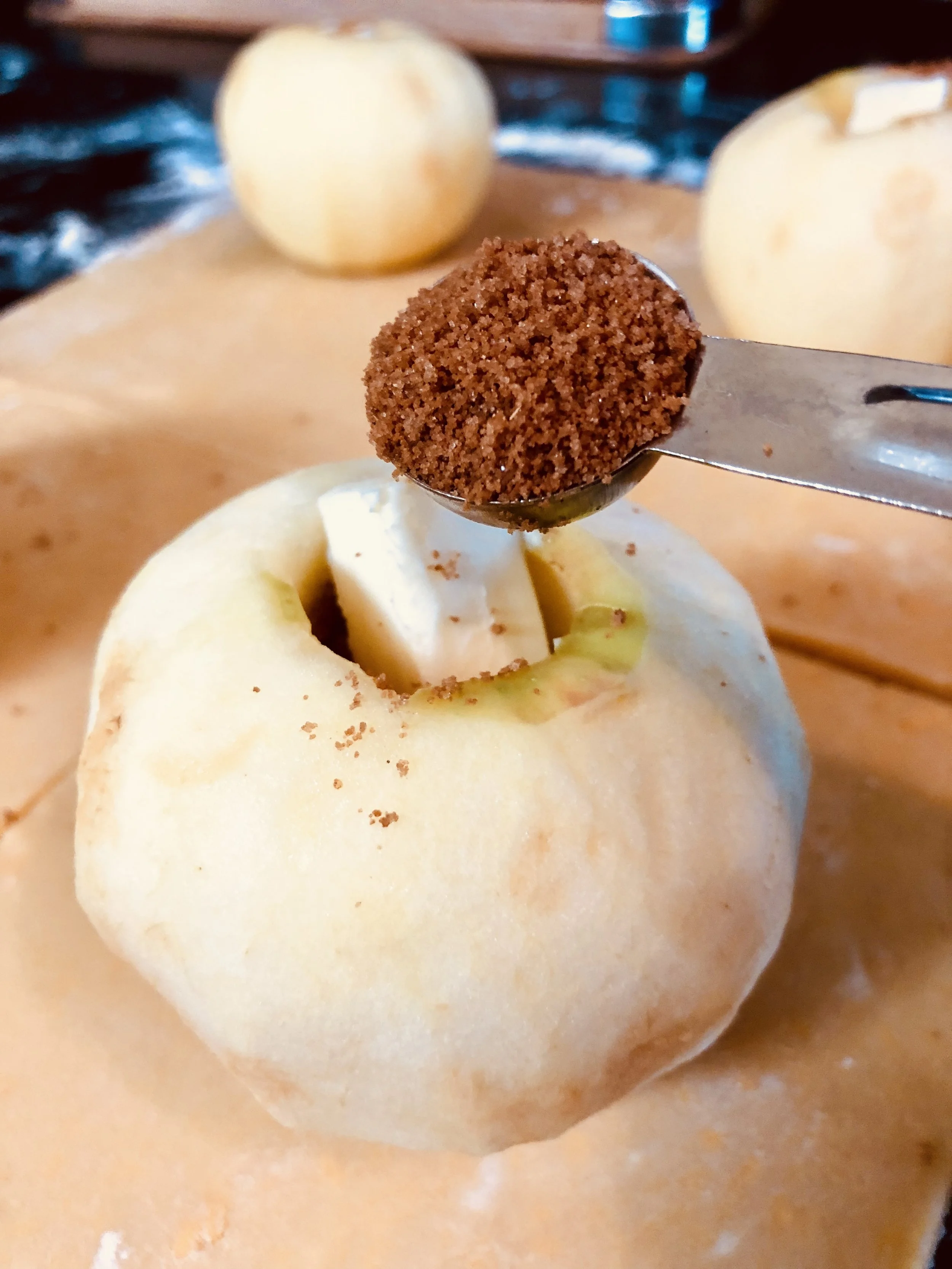 Adding the brown sugar and spice, topping with butter, and more sugar and spice!