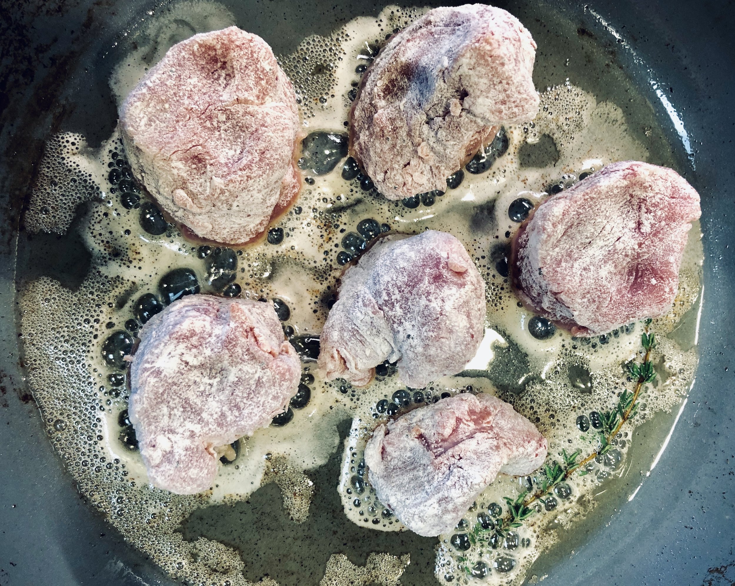Browning the medallions.
