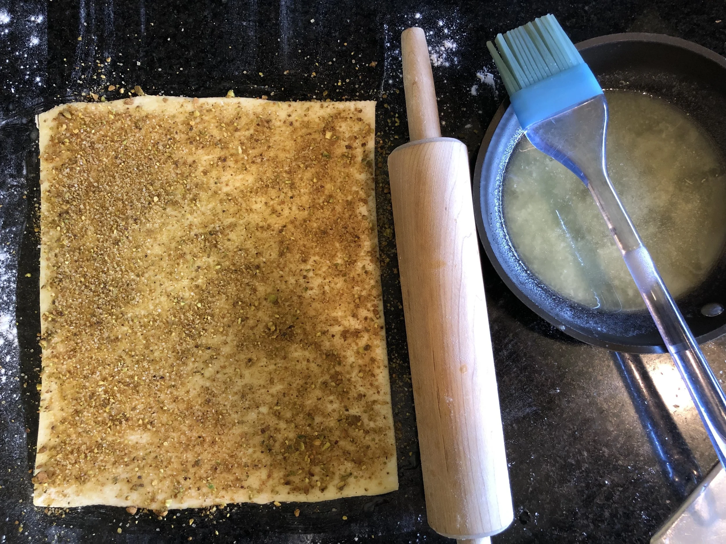 Coated with melted butter then the pistachio, sugar, and spice mixture.
