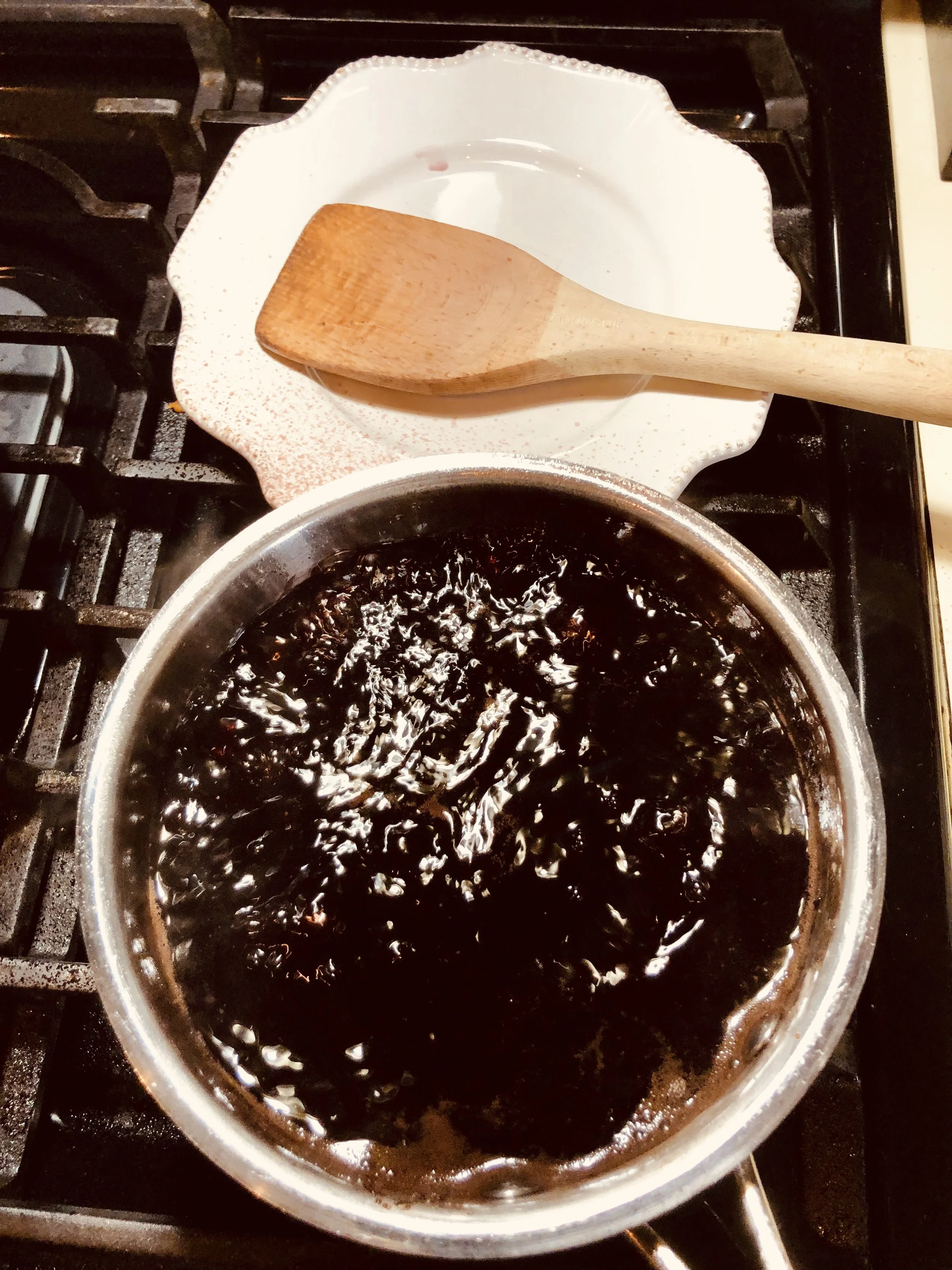 Reducing the pomegranate juice, sugar, and lemon juice.
