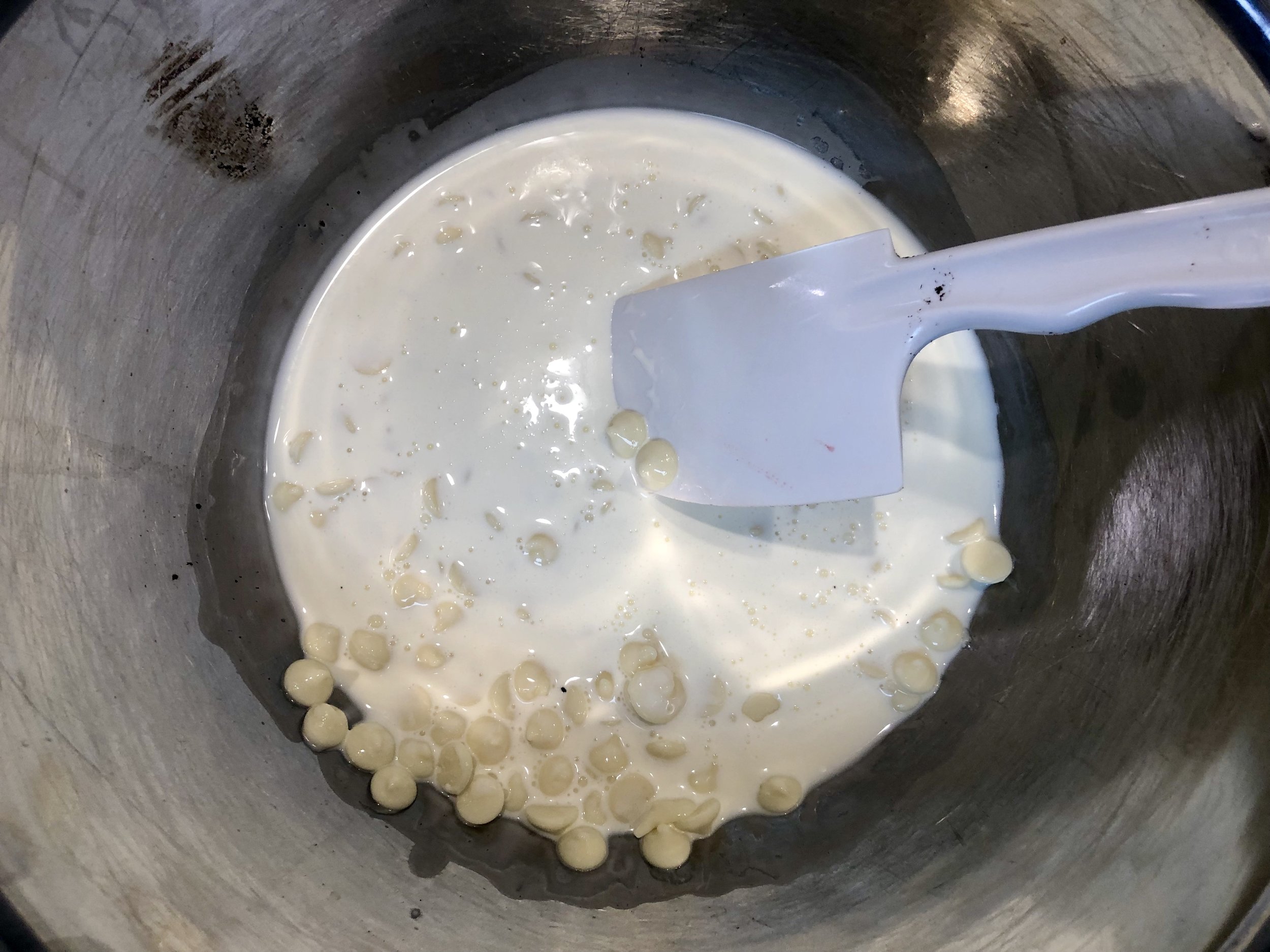 Melt the white chocolate into the heavy cream over a double boiler.