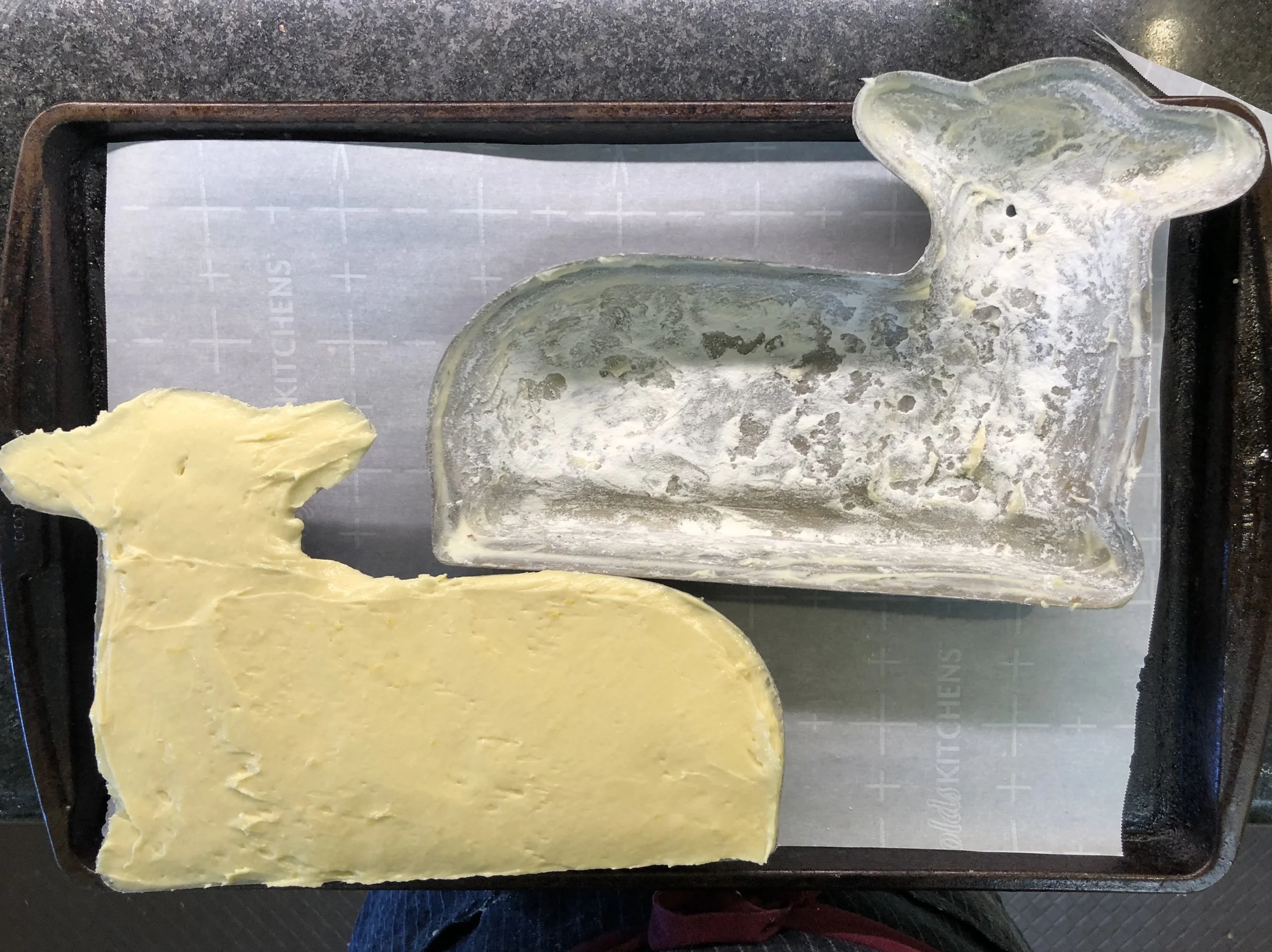 The cake batter is filled and smoothed out to the very top of the front facing half of the cake mold.