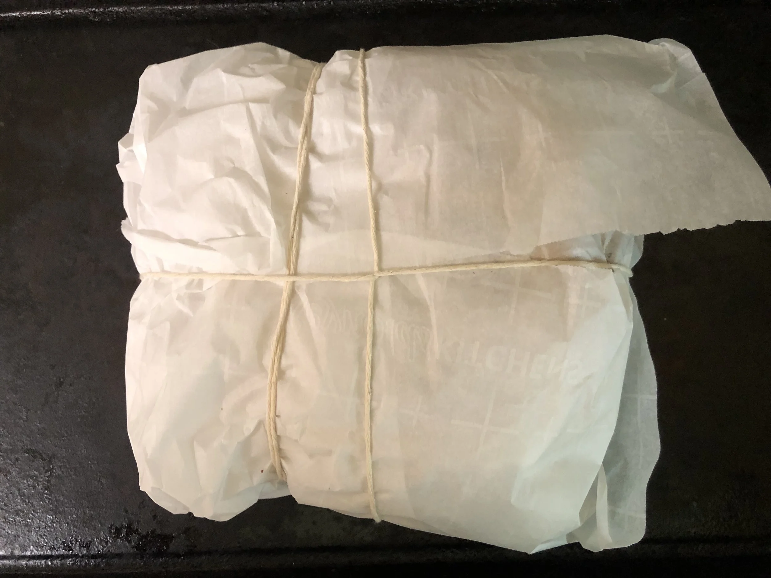 Wrap the sandwich in parchment paper, tie with roasting twine to secure.