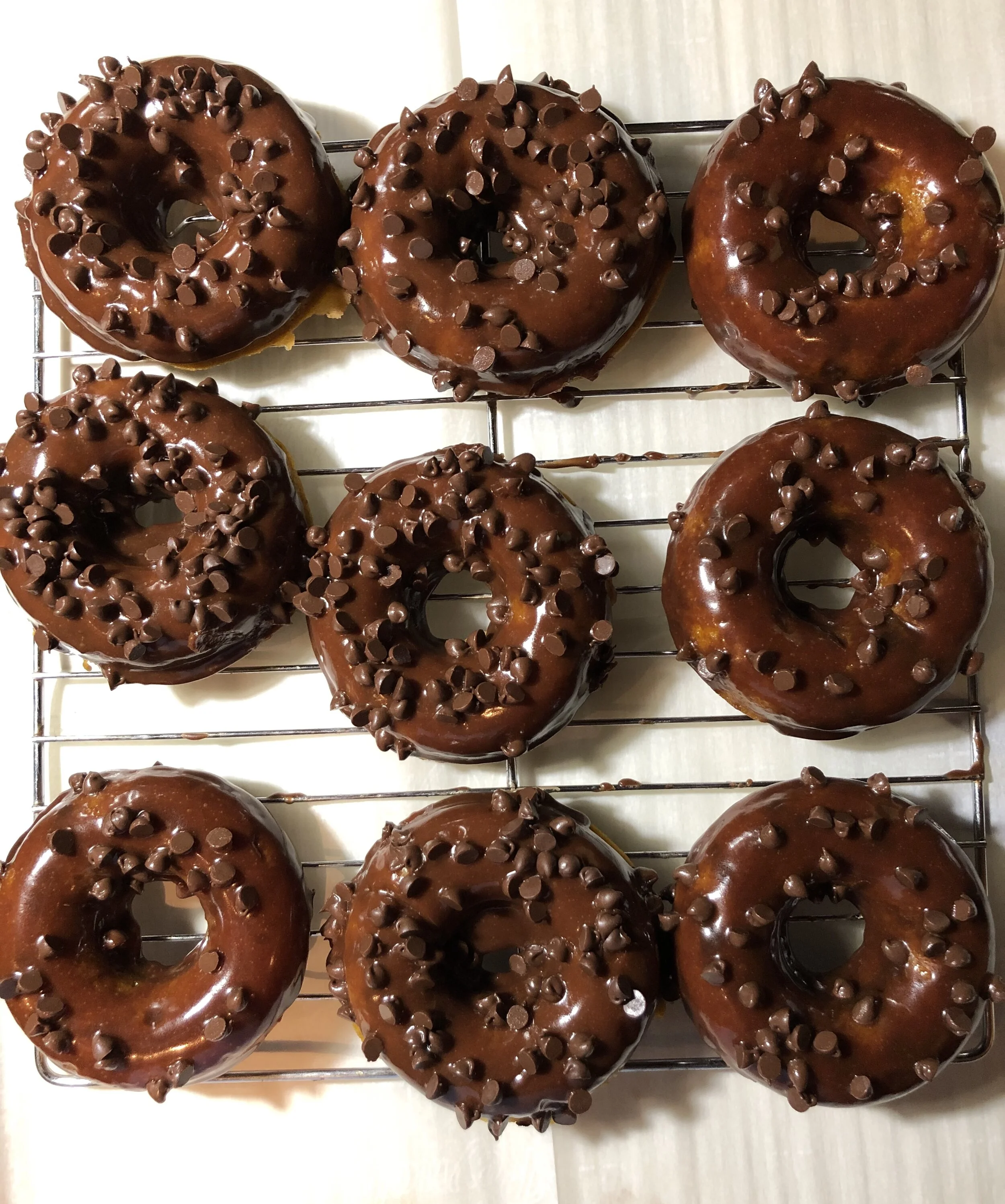 Pumpkin Chocolate-Chip Baked Donuts coated in a Chocolate Bourbon Glaze