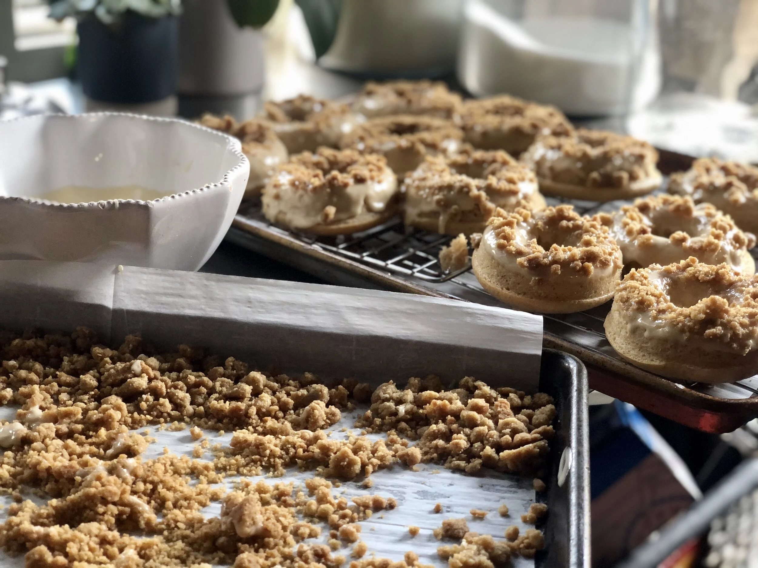 Baked, Glazed, And dipped in the crumb topping. All that’s left is to open wide!