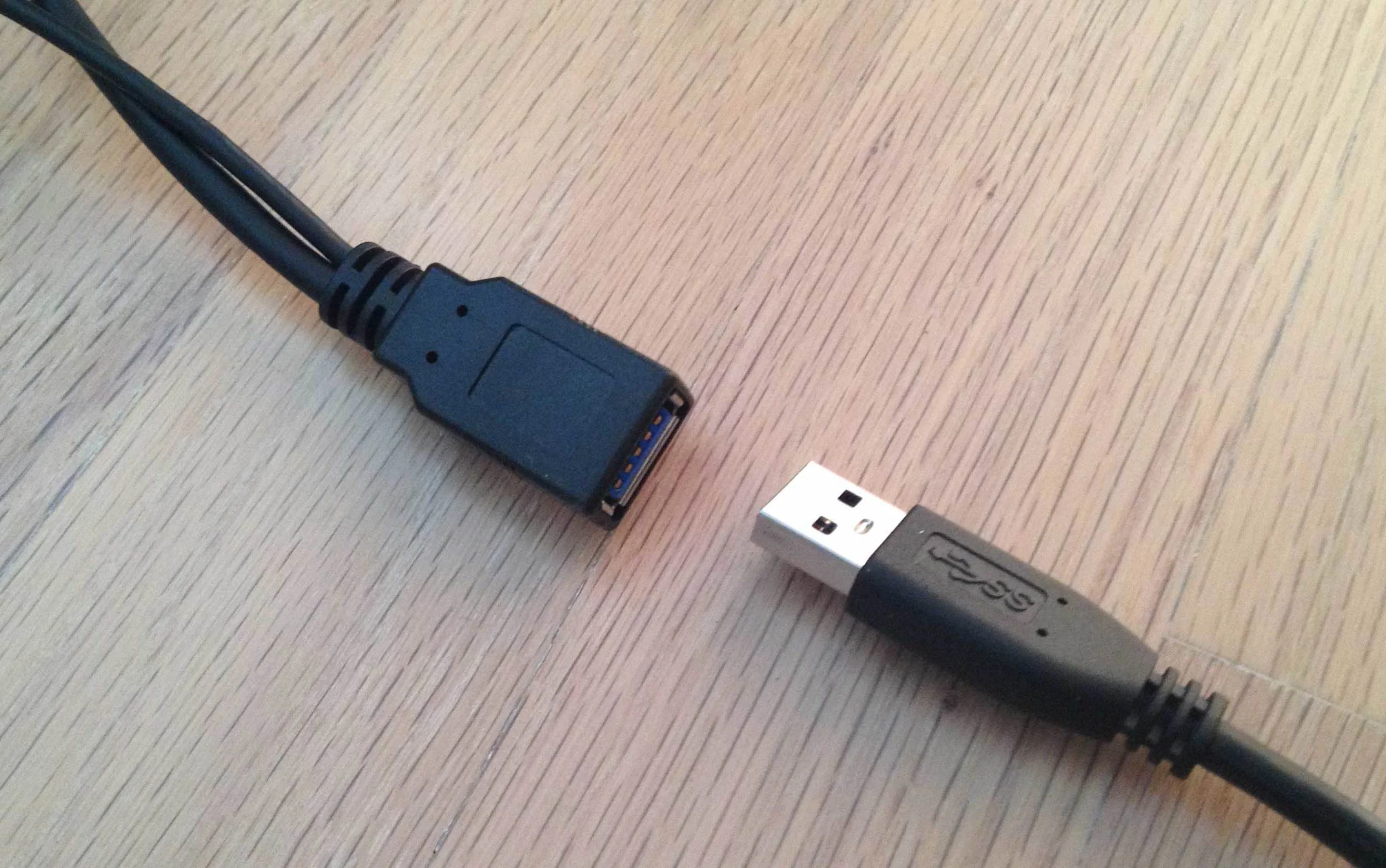 The USB 3.0 male end attaches to the female end of the USB 3.0 Y cable (left). Notice that one of the cords on the Y cable is thinner.