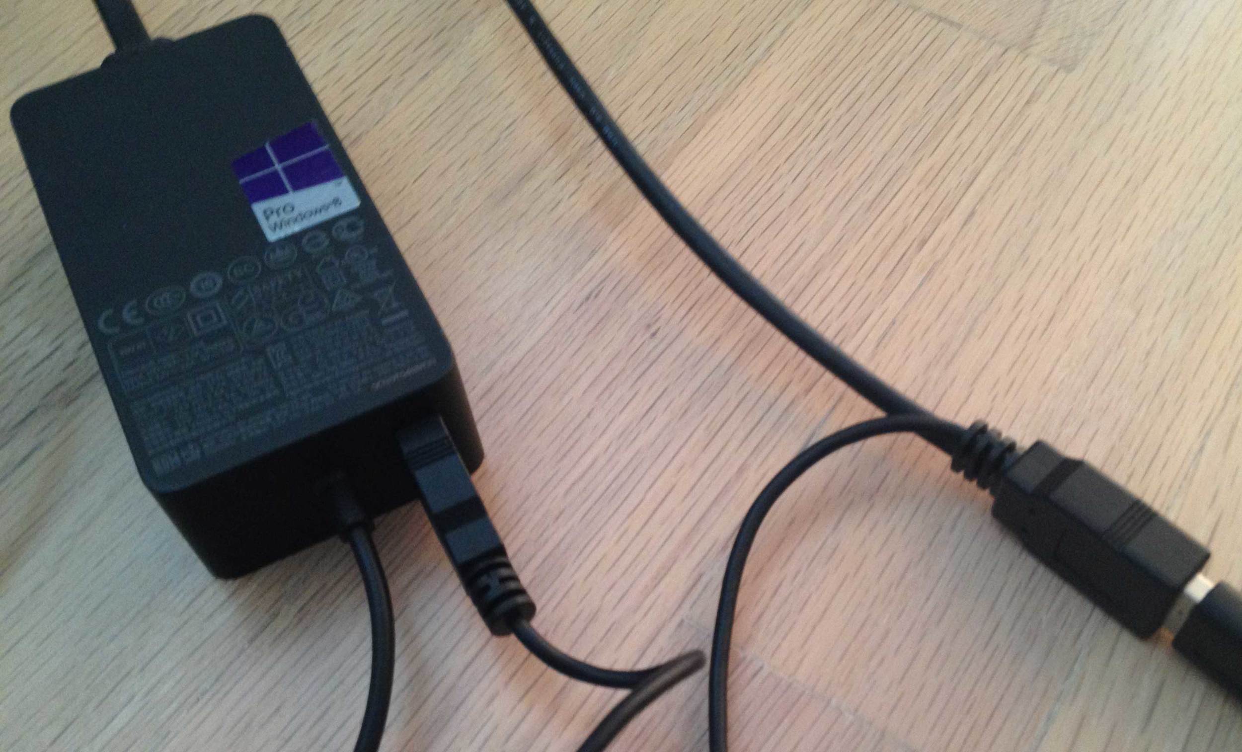 The thin cable from the Y attaches to the USB input on the Surface Pro power adapter (left). This cord is only about 12 inches long and the SP's power plug cable is also very short. You'll probably need a power extension cord to use this set-up comfortably on your desktop.