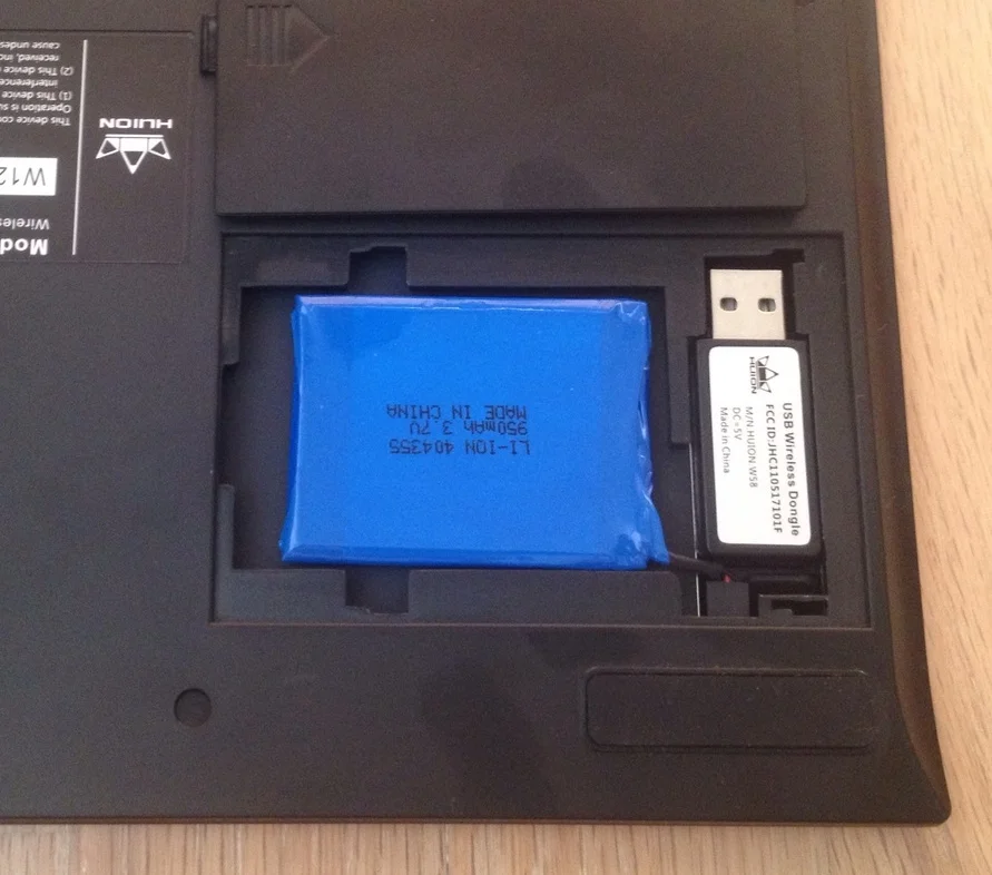 On the backside of the tablet, the battery compartment opens to reveal the rechargeable lithium ion battery the USB wireless adapter to plug into your pc.