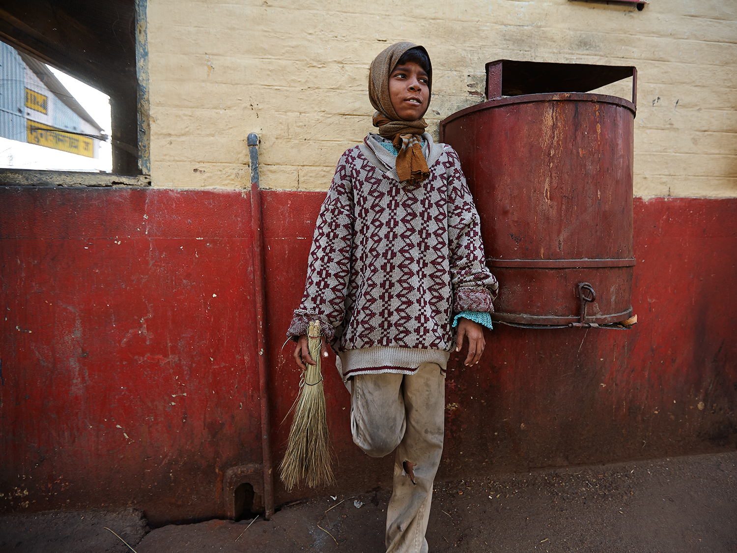 A train sweeper relaxing between sweeping trains at the Mughal Sarai Station