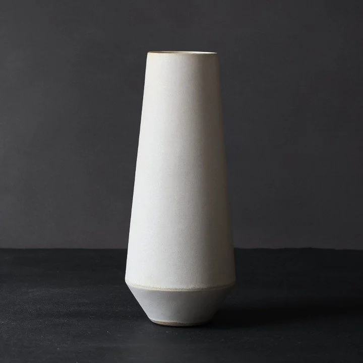 Column and Font. Two vases from the same system &mdash; one vertical, one with volume.⁠
⁠
Column narrows upward. Font widens at the belly and tightens at the mouth. Both stand nine inches. Both work without flowers.⁠
⁠
Same clay, same glaze, same ung