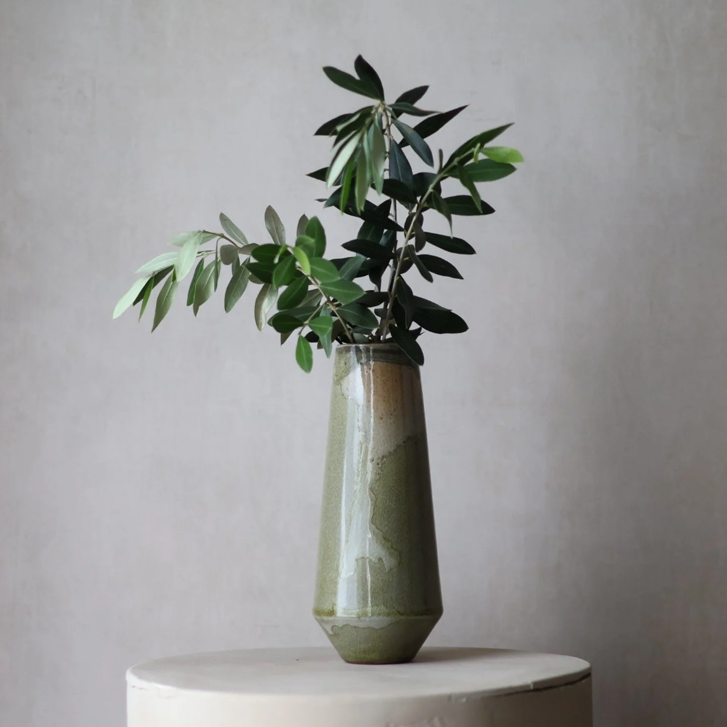 Shino stoneware vases and cups &mdash; pieces from a limited collection I've been working on.⁠
⁠
Same kiln. Same glaze. The vases trapped carbon into the surface &mdash; mossy green with bands of peach where the atmosphere shifted at the shoulder. Th