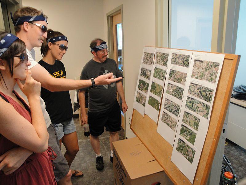 A group of "Spies" plan their attack on scavenger hunt teams using aerial images of checkpoint locations