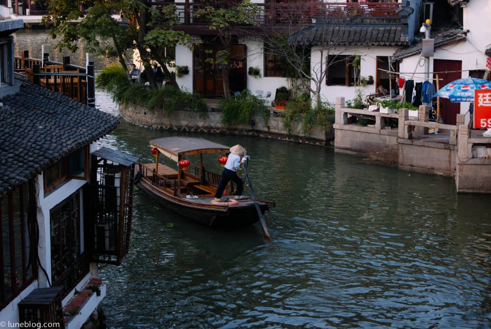 Local paddling the river through Watertown, outside Shanghai.