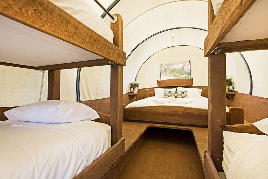 Get a cozy night sleep in a covered wagon - this one sleeps 6!