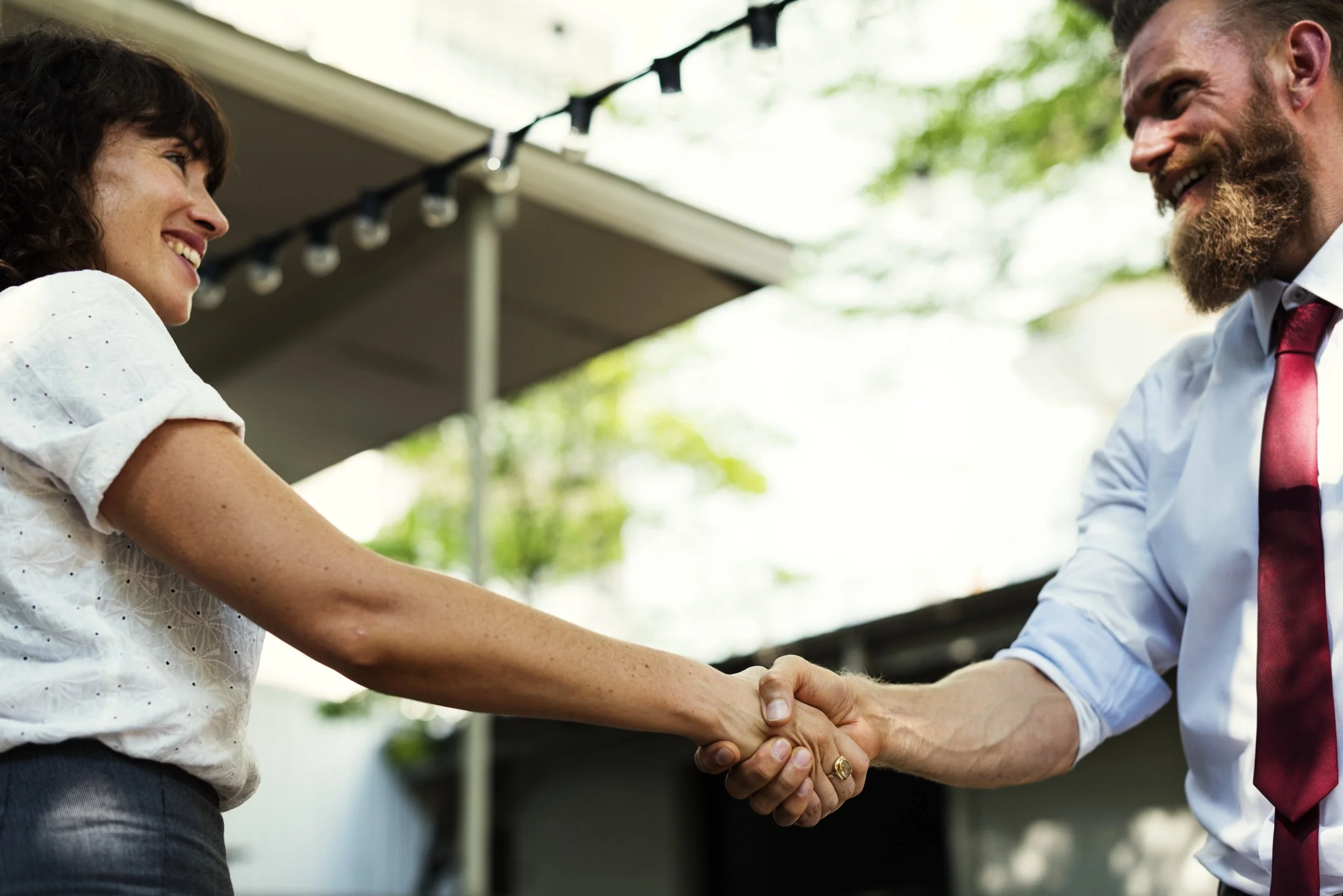 Man and woman shaking hands. Photo by rawpixel on Unsplash