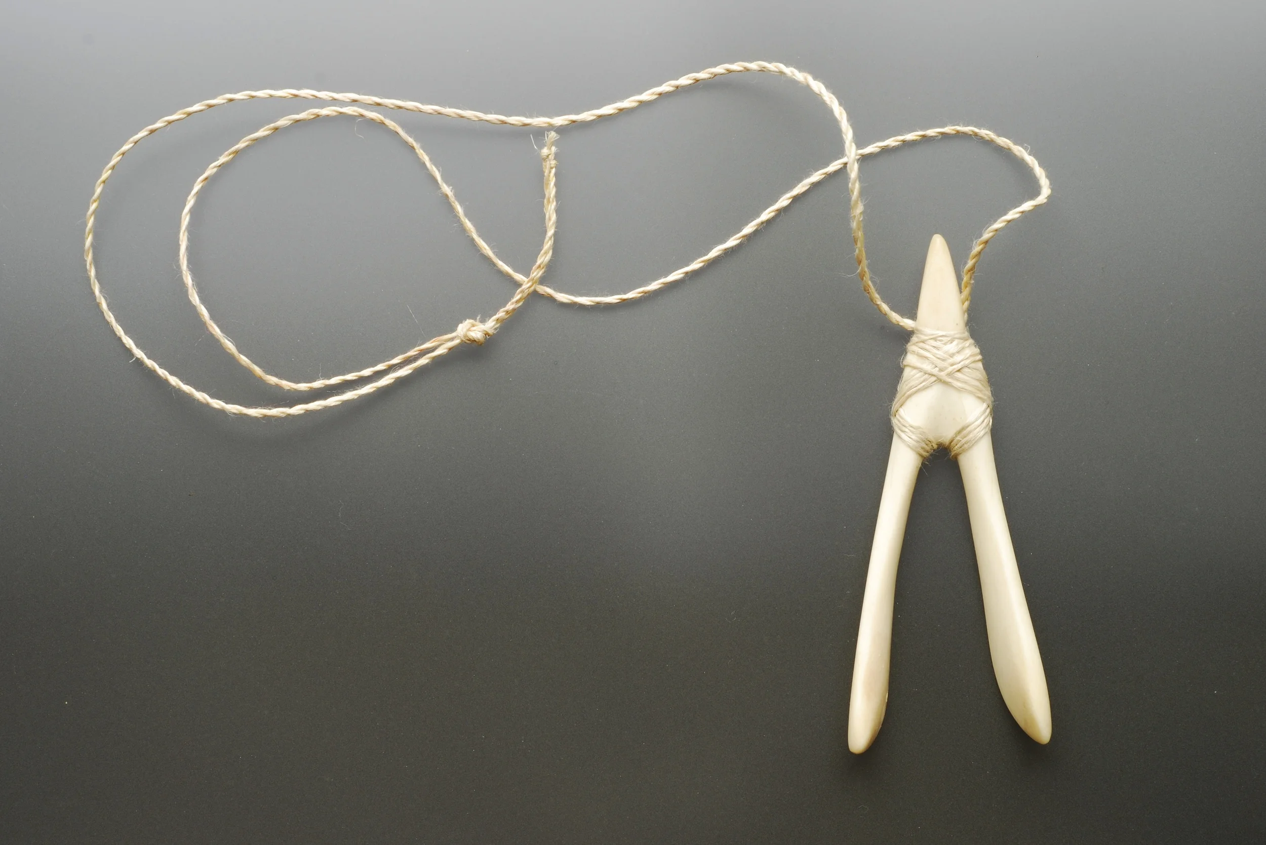 Wishbone Pendant 2012, bone, muka cord.