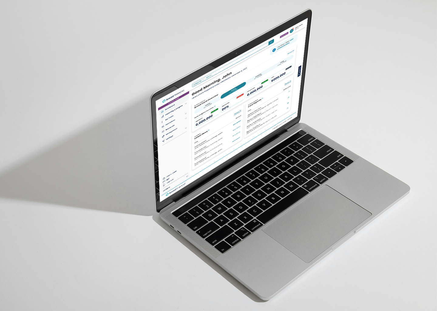 A silver laptop showing a financial dashboard on a white surface with a shadow cast to the left.