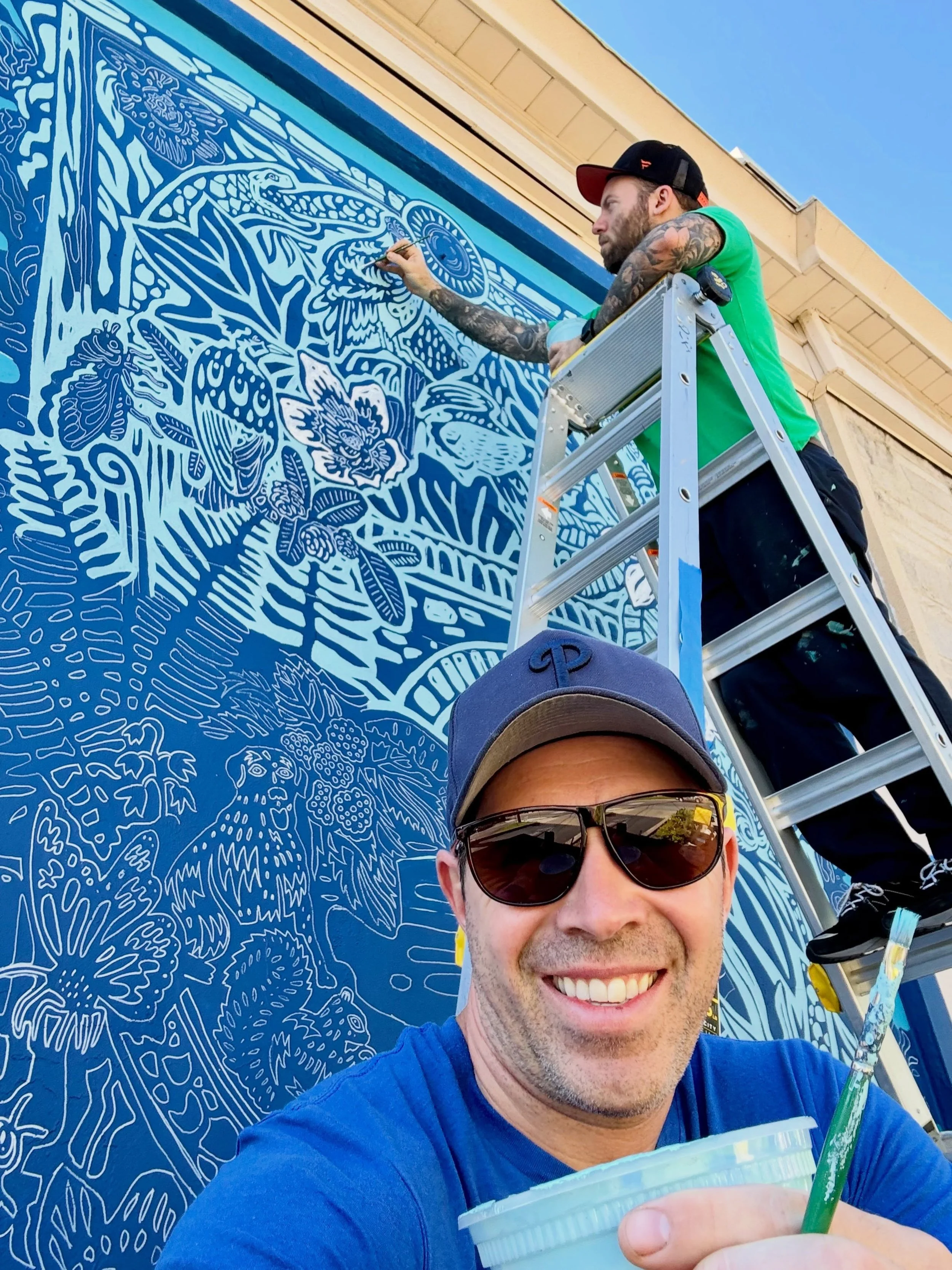 We out here 🤳 🎨 😎 💙 🩵 
@localscoffeewyndmoor 
.
Mural assist 🏒 🥅 @botanical_funk 
.
.
.
#paulcarpenterart #mural #muralart #muralwork