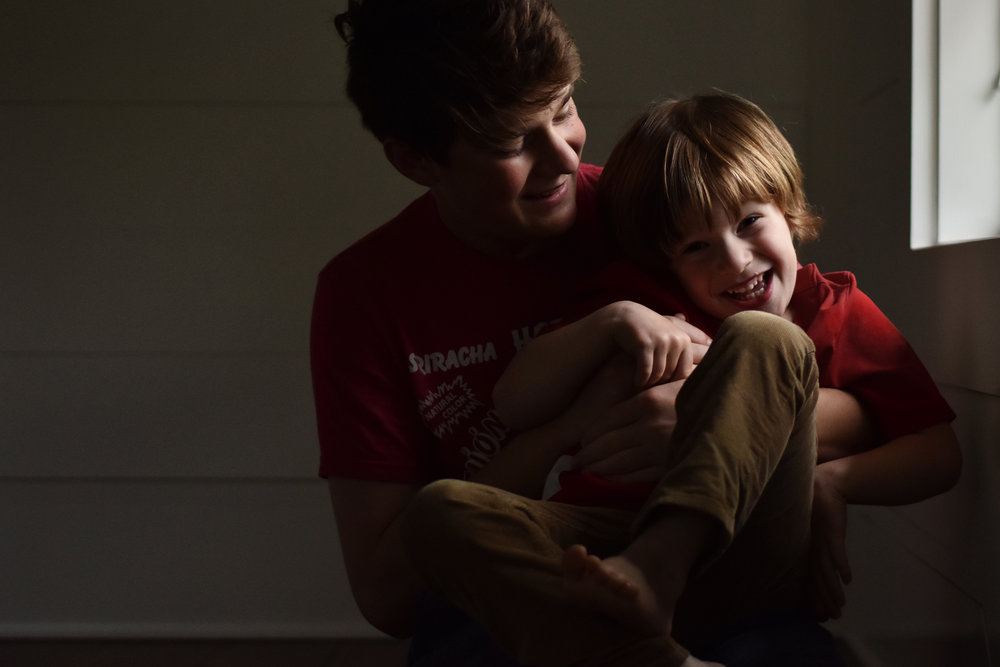 D5600 two boys smiling together by window by kellie bieser.jpg