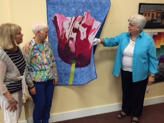 Visitors carefully examine A Poppy for Mother by Karen Ponischil of Charlotte, NC