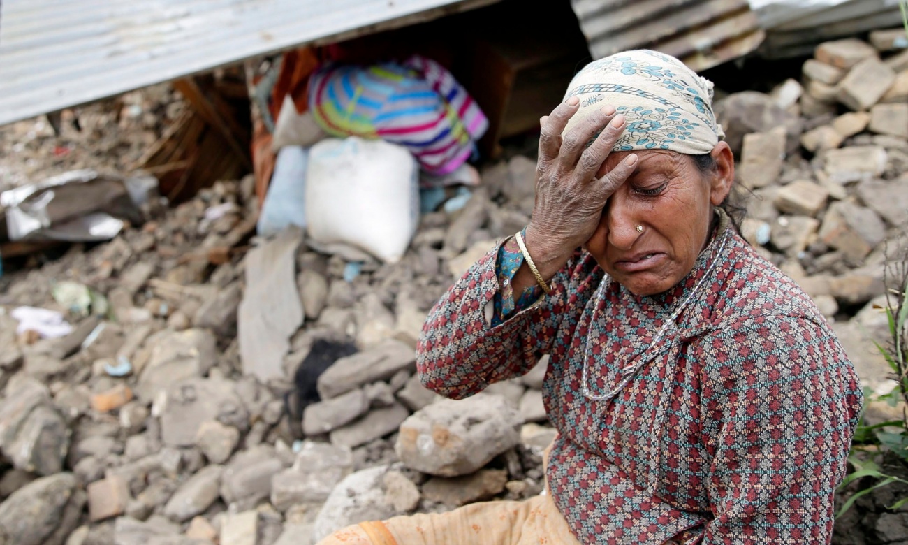 An elderly woman mourns in front of her destroyed home in the Kumalpur village, on the outskirts of capital Kathmandu. Photograph: Narendra Shrestha/EPA (from The Guardian)