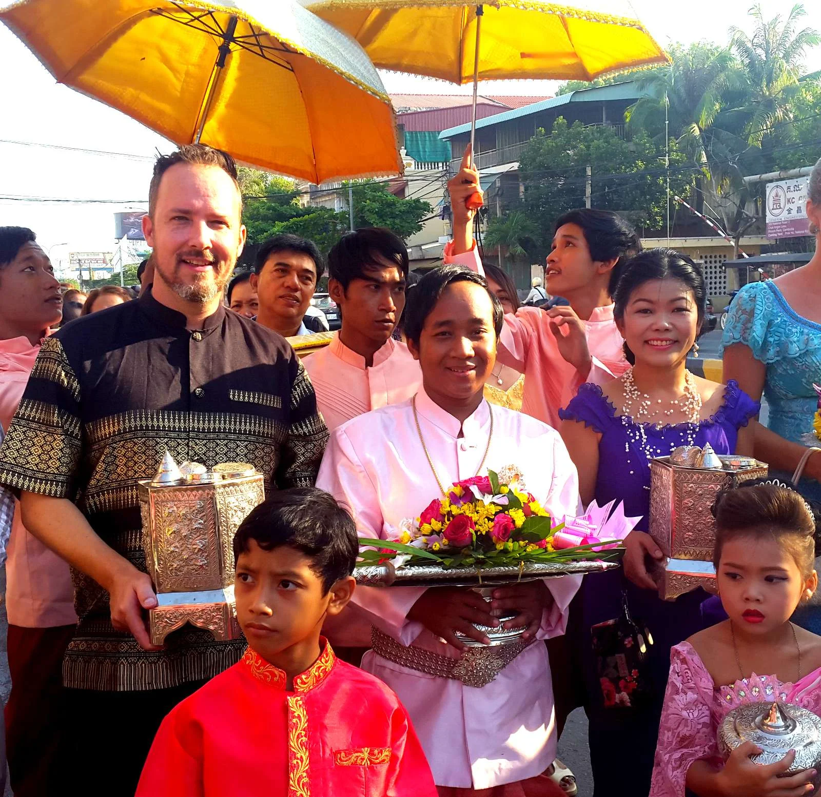 Theara (center holding flowers) on the wedding procession to offer gifts to the bride's family