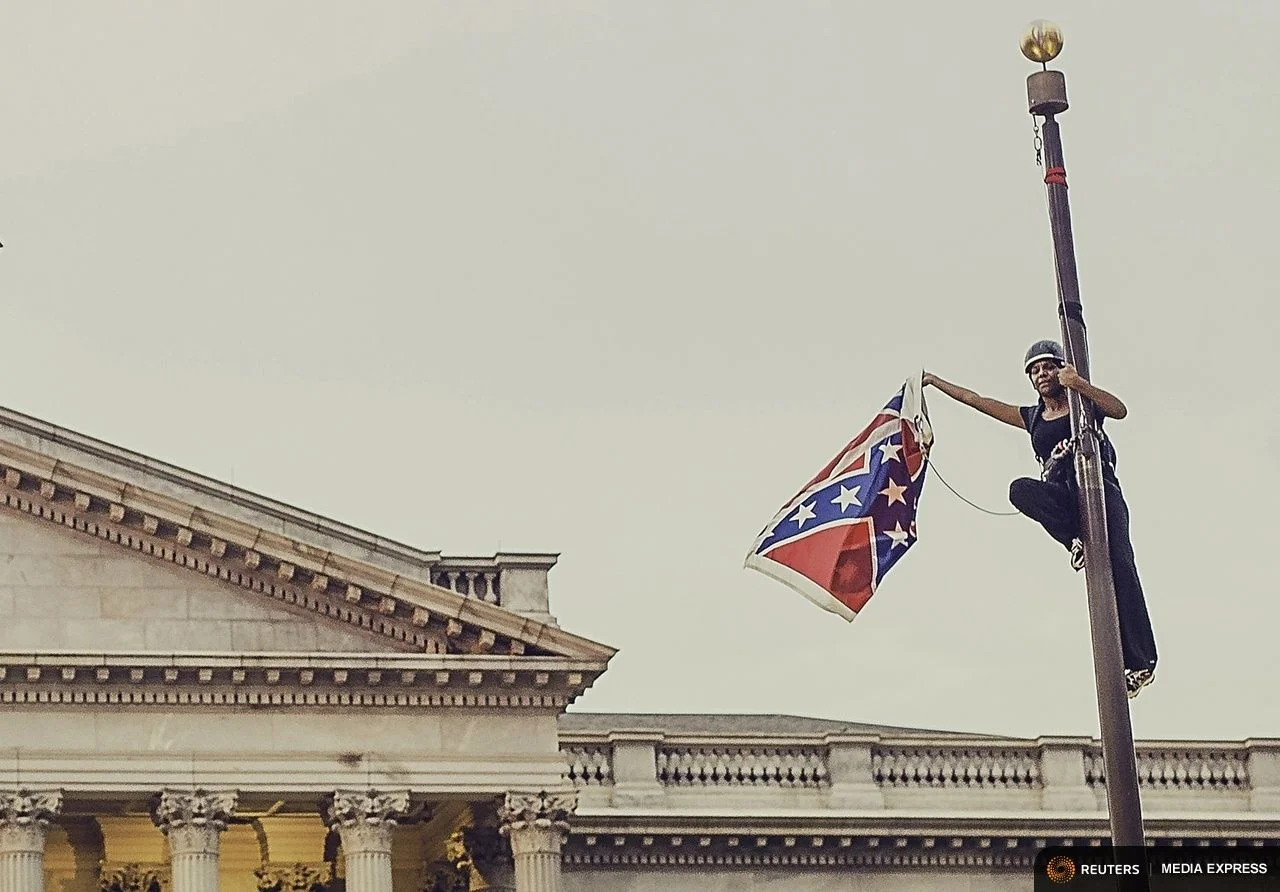 Bree Newsome pulling down the racist Confederate flag.