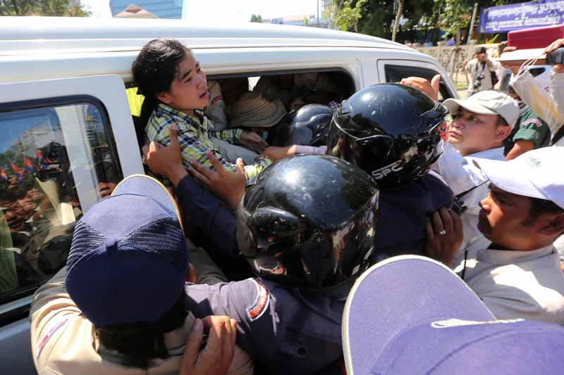 Physically tiny but courageous Cambodian activist, Tep Vanny, being arrested by Cambodian police in riot gear.