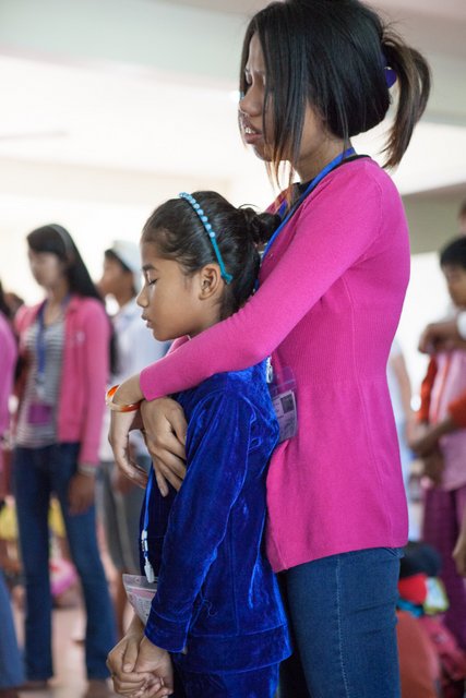 An Alongsider praying for her "little sister" (who is also her neighbor)