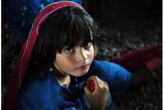A young Afghan refugee at the UN registration centre in Pakistan, is among more than 43 million displaced persons worldwide. (Image: A. Majeed / AFP)