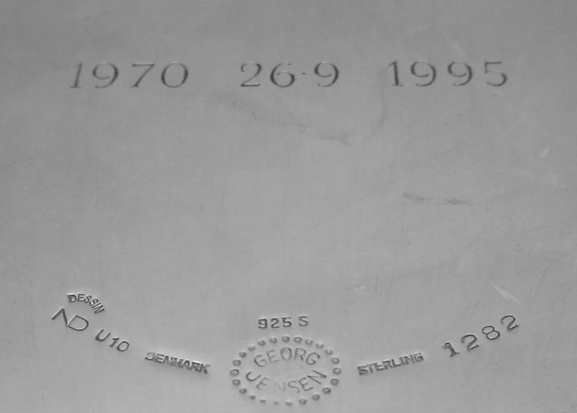 The U10 mark present on this Nanna Ditzel piece is actually a year mark. After Georg Jensen had purchased the A Michelson silversmithy, they began introducing the Swedish dating system to some pieces. the U10 follows with the chart HERE to show that this particular piece was made in 1994. (the engraved dates were added later at the bequest of the former owner)