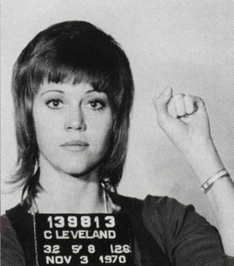 " I have gotten a lot of questions about my mug shot–what’s the story behind it? Is it a real mug shot? So here’s an abbreviated answer:
Late in 1970, I was starting a nationwide speaking tour about the Vietnam War and, in particular, about the Winter Soldier Investigation (WSI) that some of us were organizing together with Vietnam Veterans Against the War. WSI was to take place in Detroit in early 1971, an American version of theBertrand Russell Tribunal aiming to prove what soldiers and many of us in the anti-war movement already knew: The My Lai massacre, while greater in numbers of people killed at one time, was not an isolated incident, but a not-uncommon occurrence that was part and parcel of the U.S.’s war strategy.
My job was to raise money (all my speaking fees from the tour went to fund WSI) and recruit GIs who had seen or committed atrocities in Vietnam. You may wonder why someone who had committed an atrocity would want to testify. I am no psychologist but I met quite a number of soldiers who needed to heal from the psychic wounds of war by speaking out about it. About 150 such military personnel from every branch of service–Army, Navy, Marines, Special Forces–came to testify.
On the tour, I would describe what was intended with WSI and at the end of my speech I would ask veterans who wanted to be put in touch with the vets in Detroit to meet with me or with the vet who sometimes traveled with me. The comedian, Dick Gregory, also traveled with me some of the time.
My first speech was given at a college in Canada and when I re-entered the US at the Cleveland airport all my luggage was seized and gone through. They discovered a large bag containing little plastic envelopes marked (in red nail polish) ‘B’, ‘L’, ‘D’–signifying breakfast, lunch and dinner- that contained the vitamins I took with each meal. They confiscated that as well as my address book (which was photocopied) and arrested me for drug smuggling. I told them what they were but they said they were getting orders from the White House–that would be the Nixon White House. I think they hoped this “scandal” would cause the college speeches to be canceled and ruin my respectability. I was handcuffed and put in the Cleveland Jail, which is when the mug shot was taken. (I had just finished filming “Klute” so, yes, it was the Klute haircut).
Headlines across the country had the story of me being jailed on suspicion of drug smuggling. I was released on bond and months later, after every pill had been tested in a lab (with taxpayers money!) The charges were dismissed and there were a few paragraphs hidden in the back of papers that they were vitamins, not drugs.
The irony was that as a result of all the bruhaha over this, the college audiences for my speeches were never less than 2000 and sometimes as large as 10,000. Read my memoir “My Life So Far” if you want to know more. "
Jane Fonda
/via http://janefonda.com/